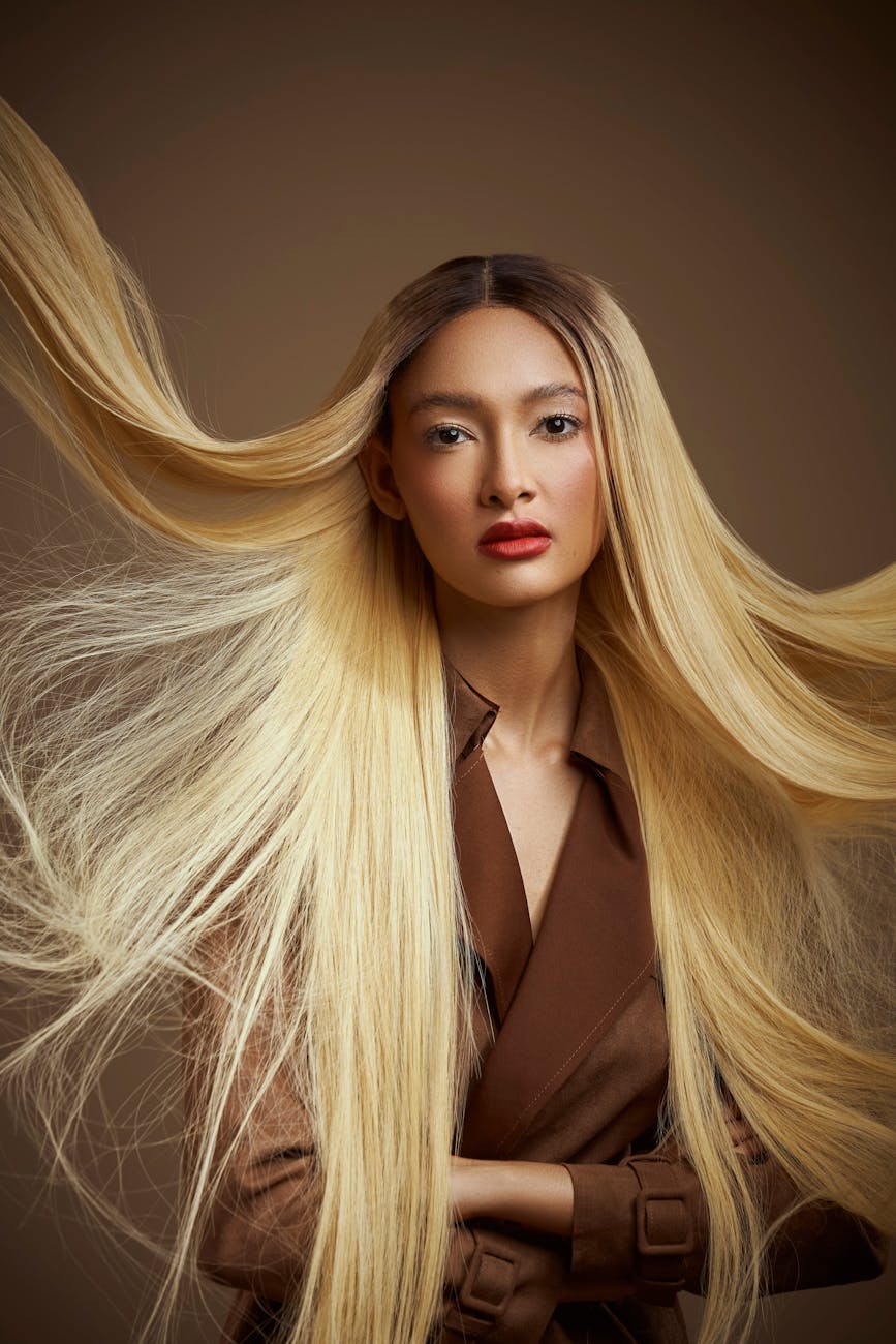 young woman with long blond hair posing in studio
