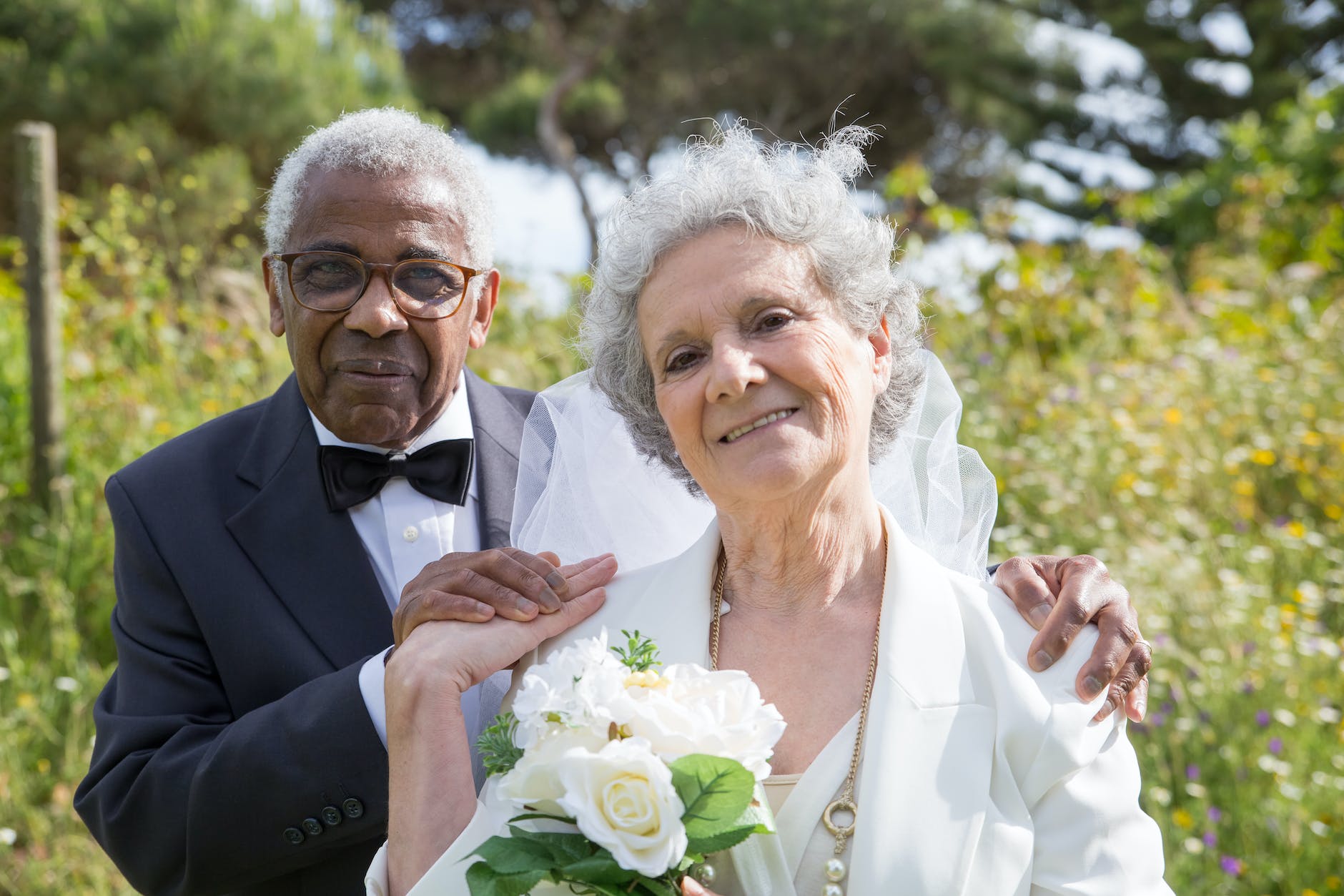 elderly bride and groom smiling