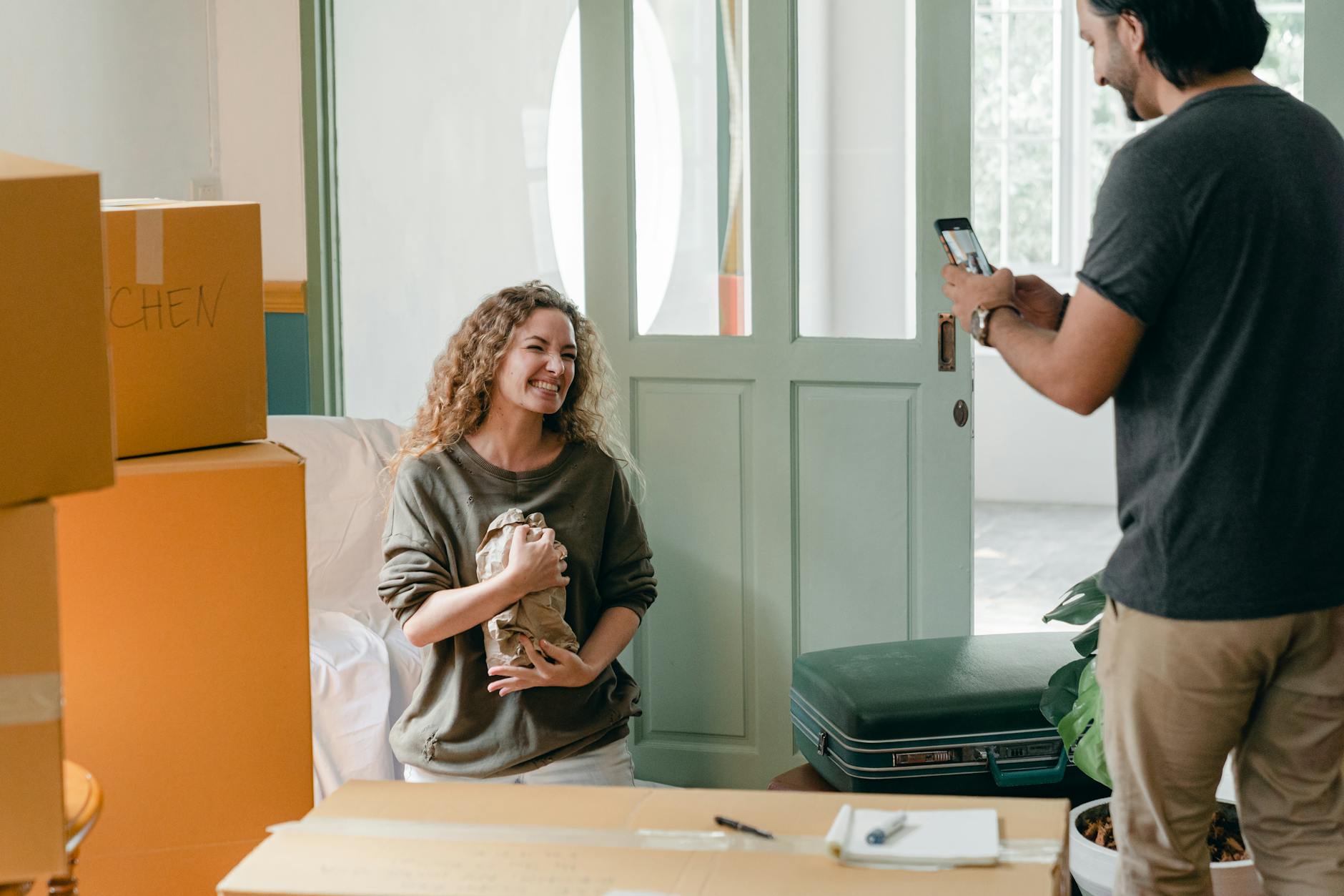 boyfriend taking photos of excited young girlfriend