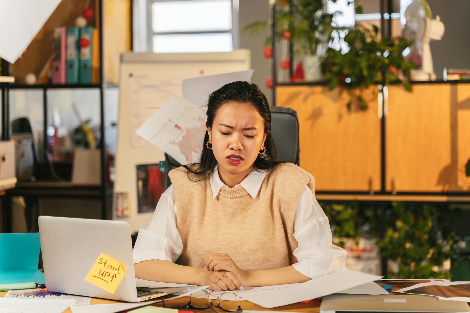 photo of a woman sitting near her laptop
