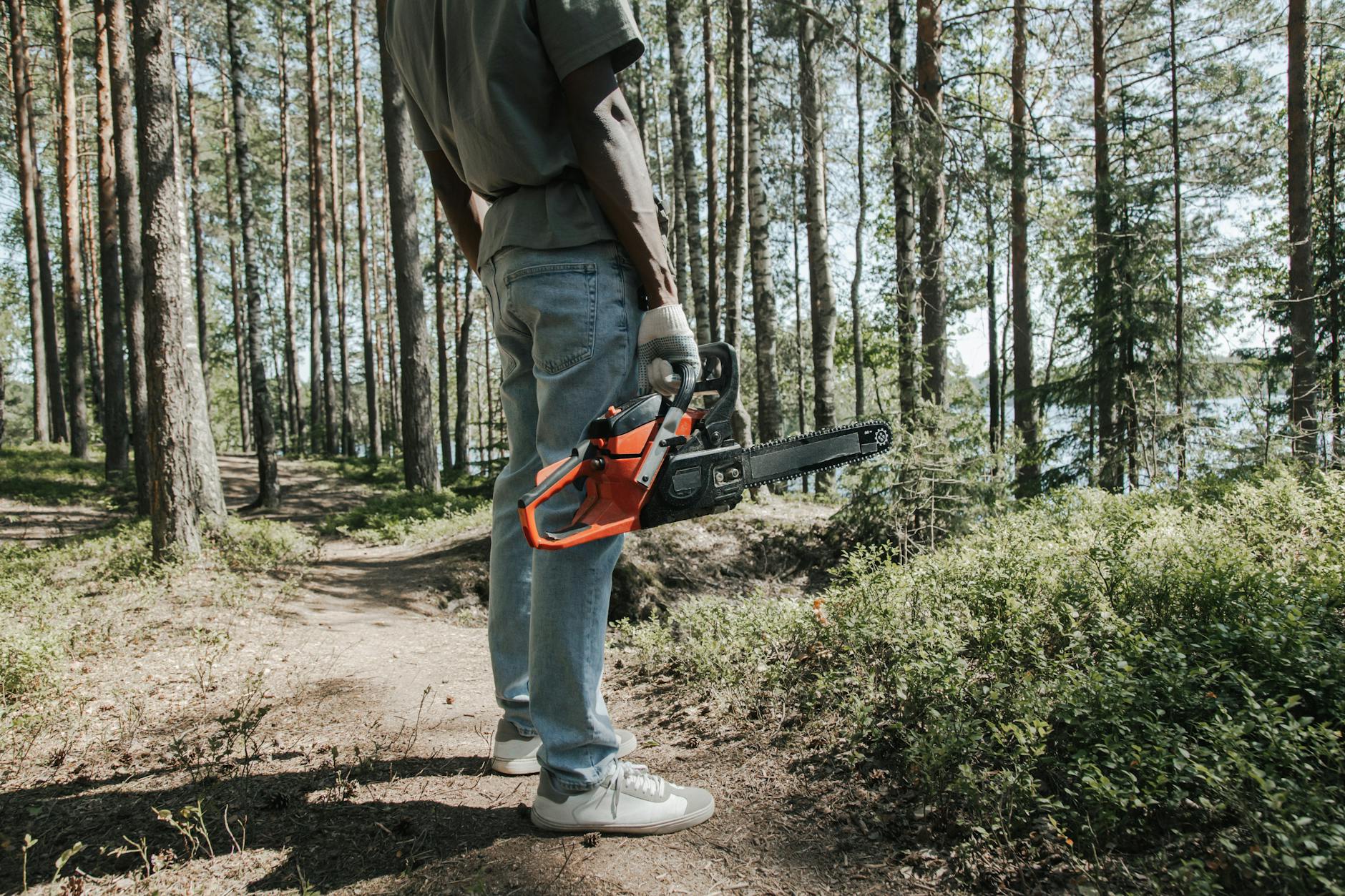 a person holding chainsaw