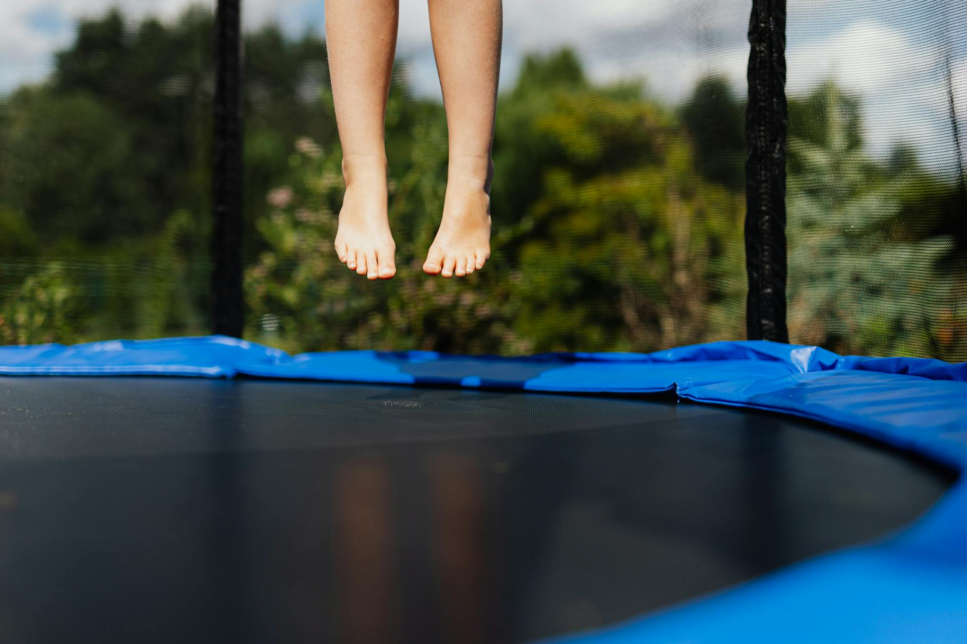 person jumping on trampoline