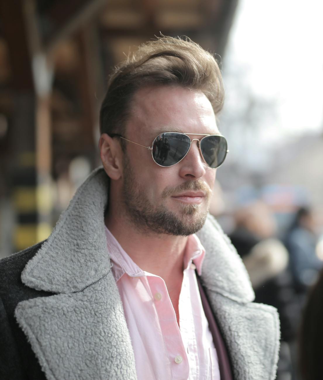 man in a coat wearing sunglasses