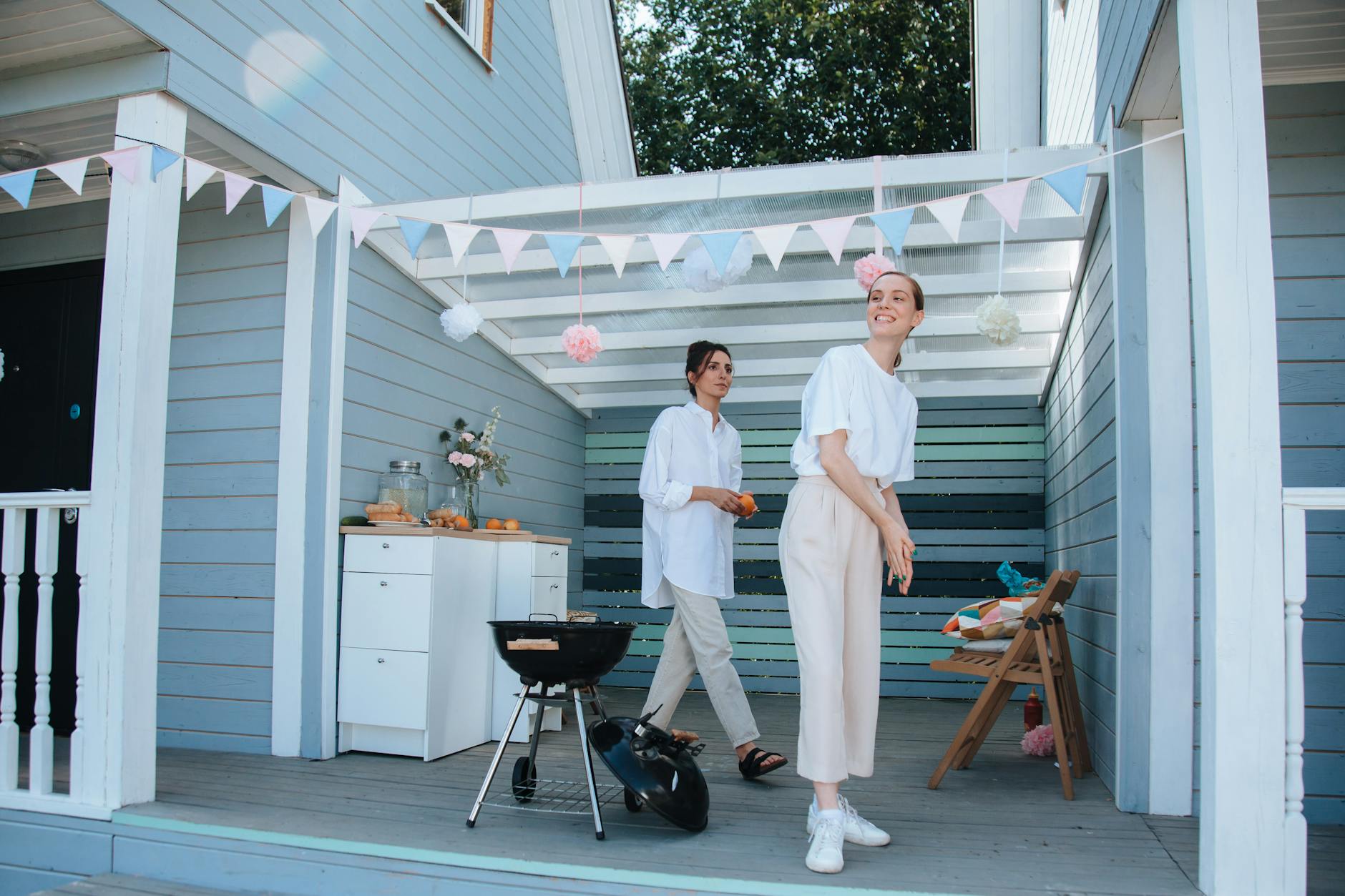 women preparing food on the porch