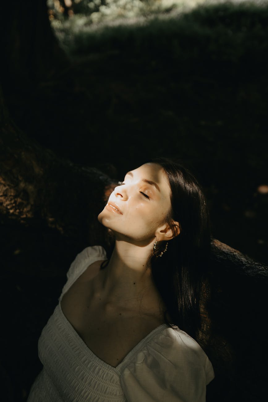 back lit shot of a woman in a white dress