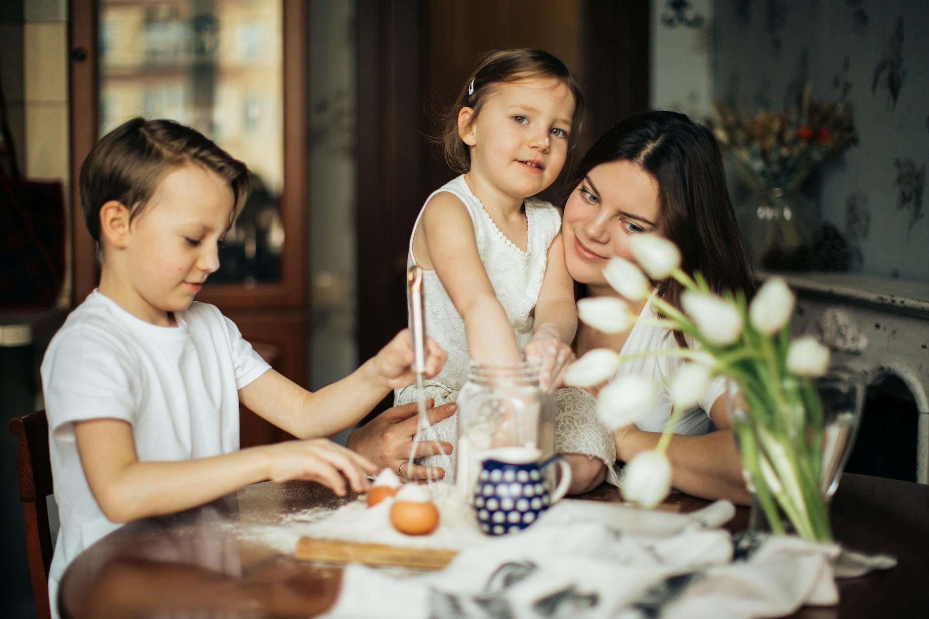 photo of woman sitting with her children