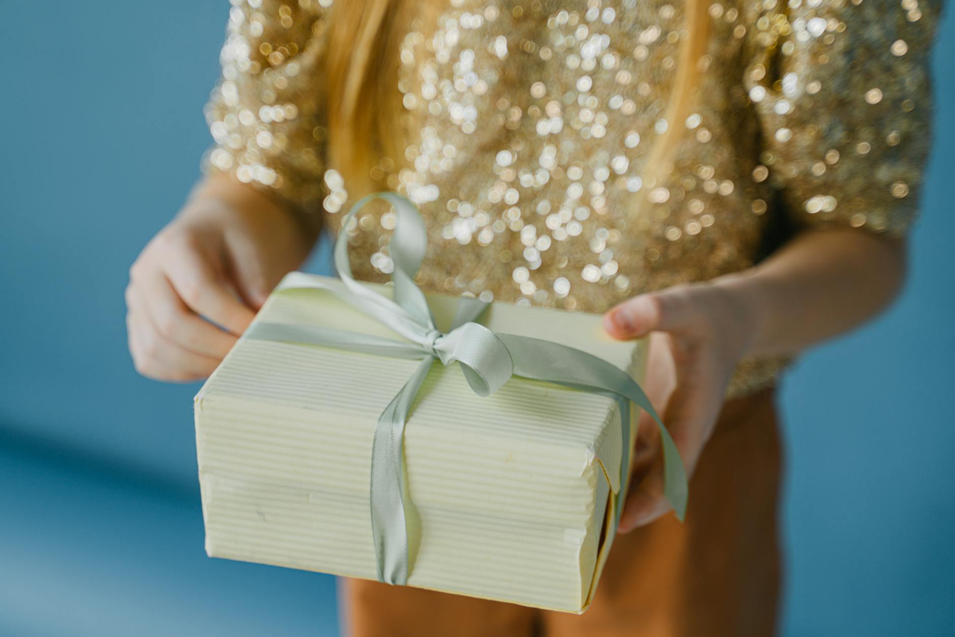 close up shot of a person holding a birthday gift