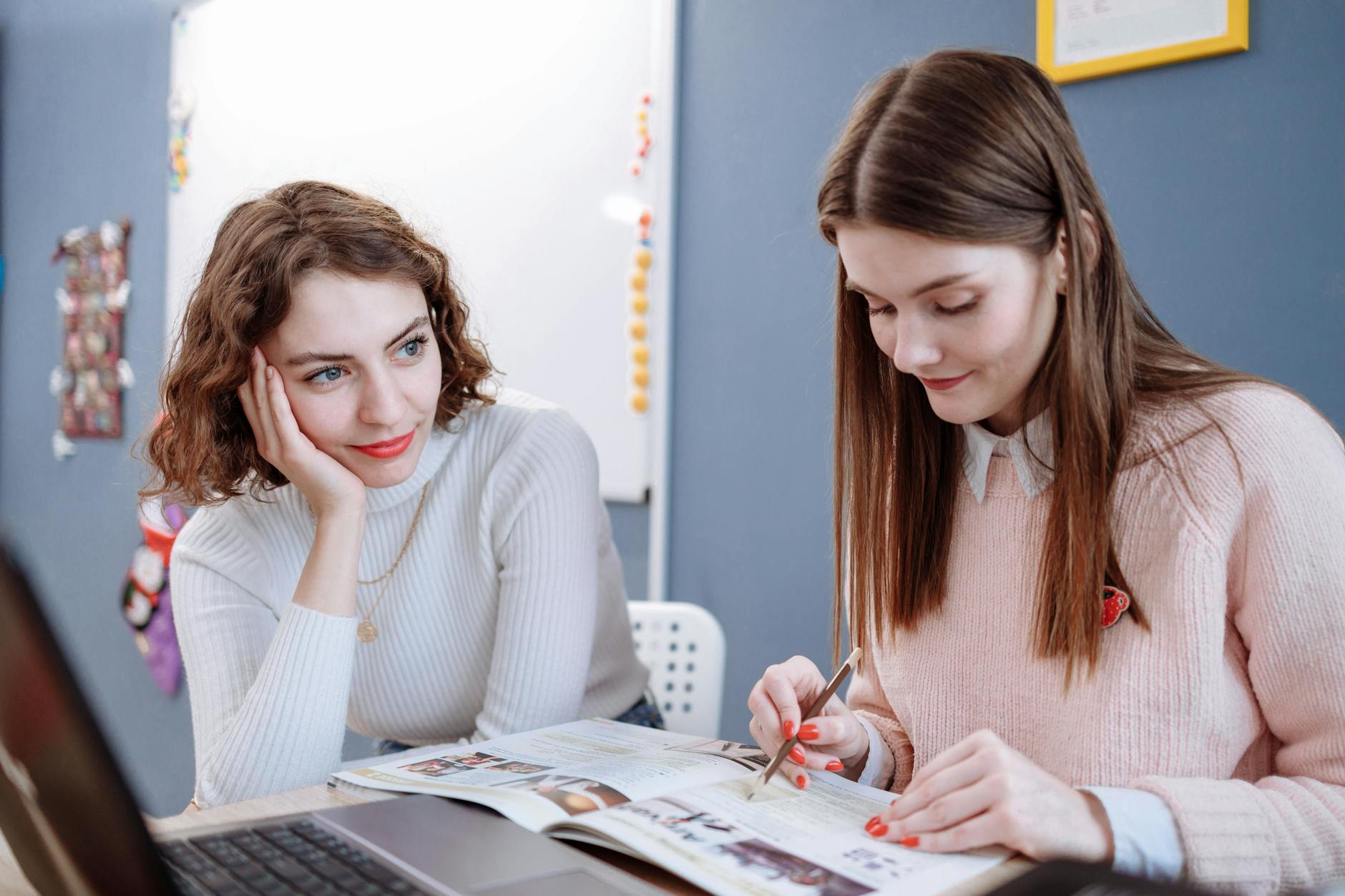 student sitting beside a teacher
