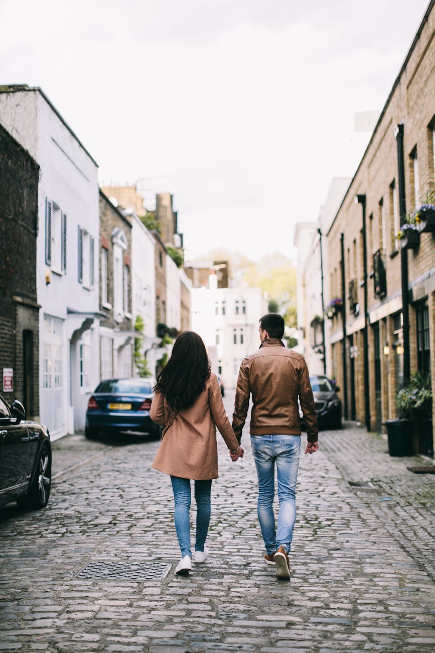 a couple holding hands while walking