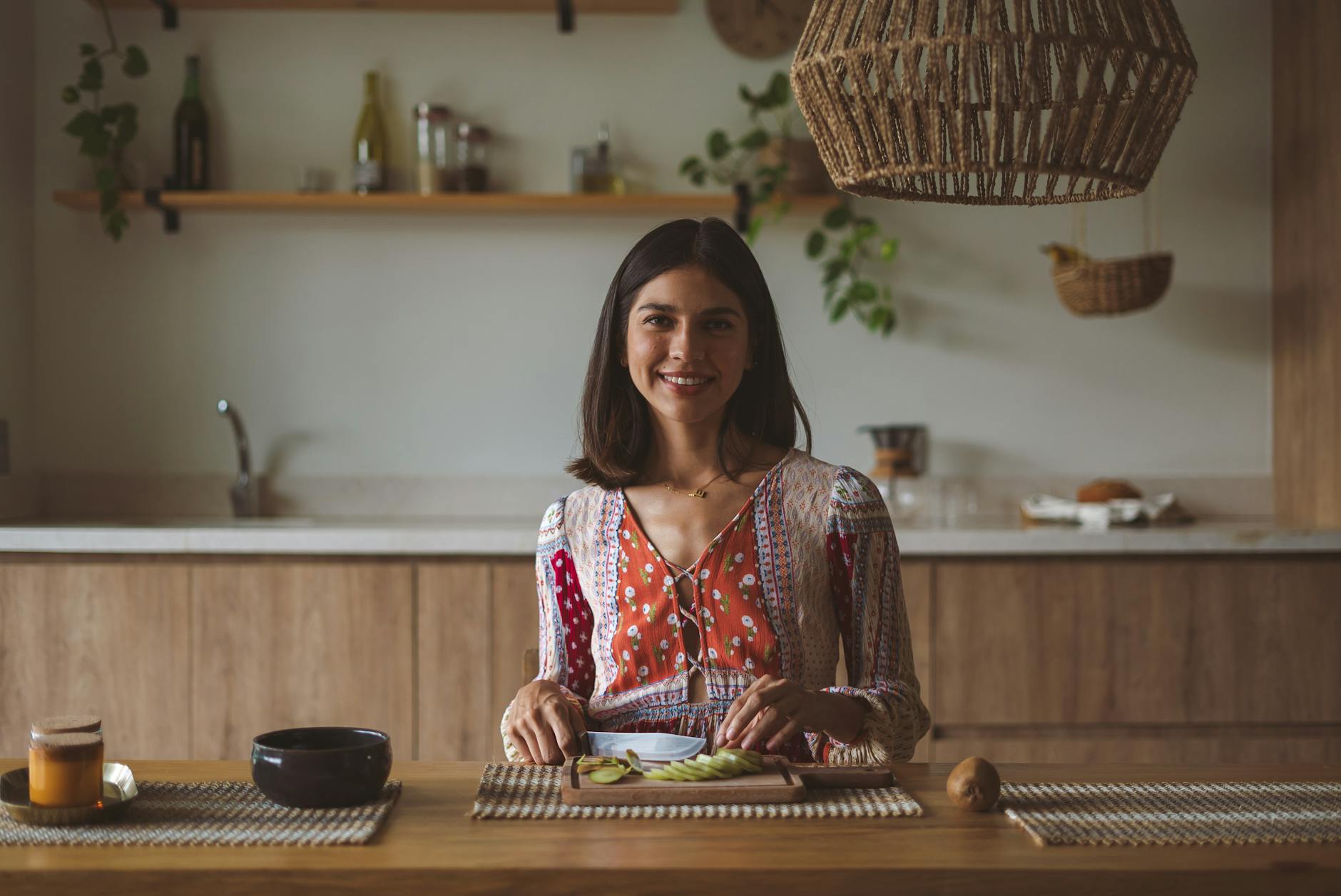 a woman smiling while holding a knife