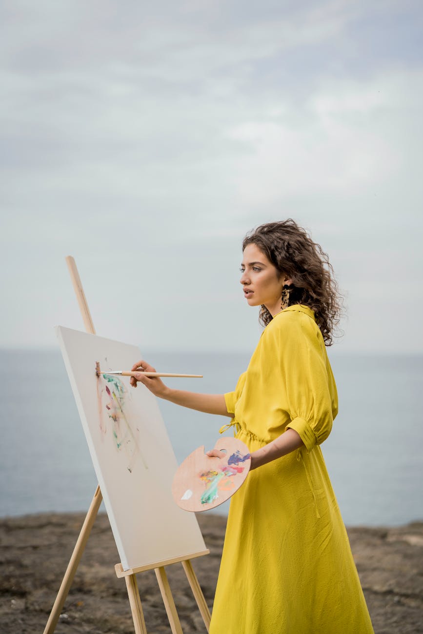 woman in yellow clothes painting