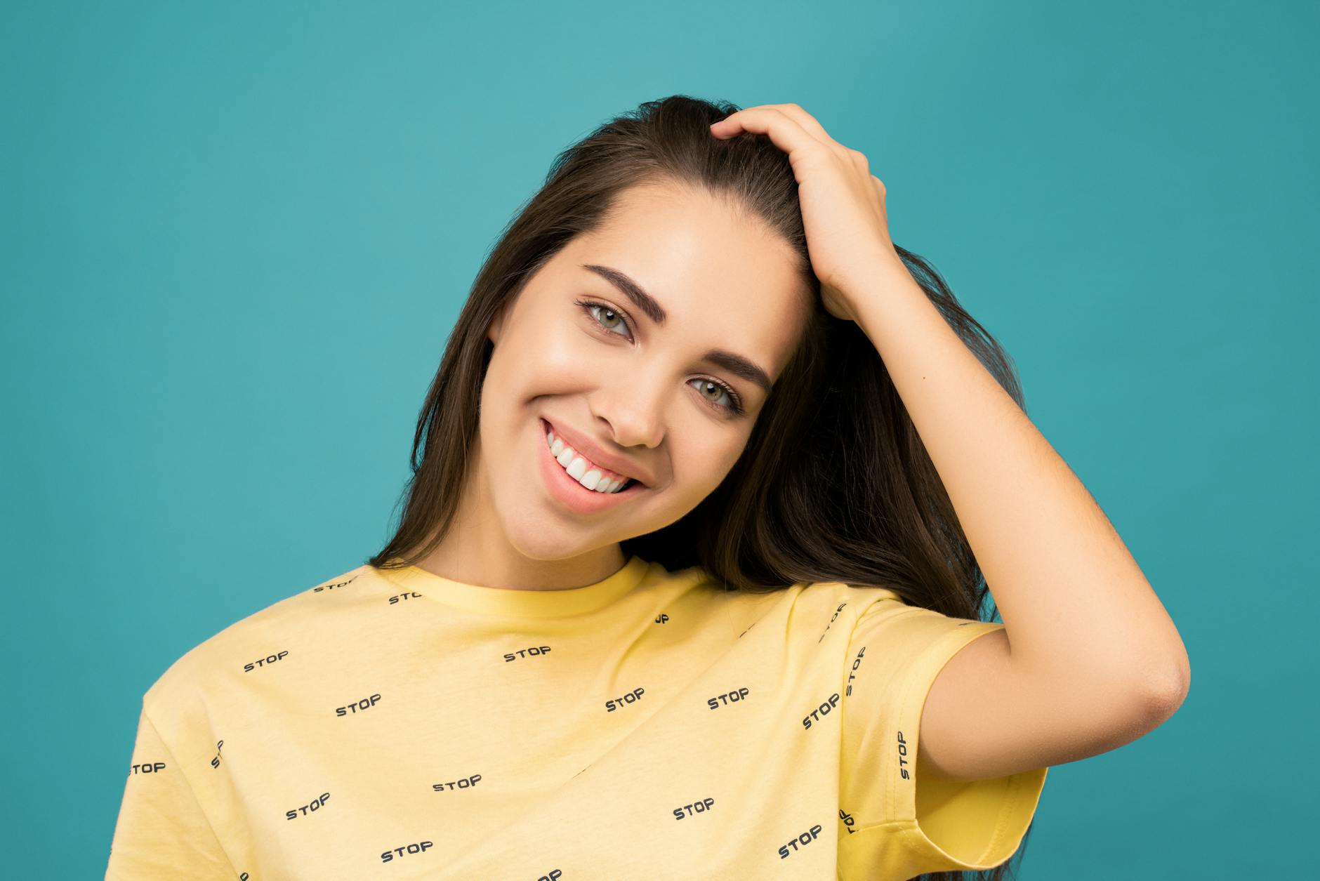 photo of smiling woman in yellow shirt