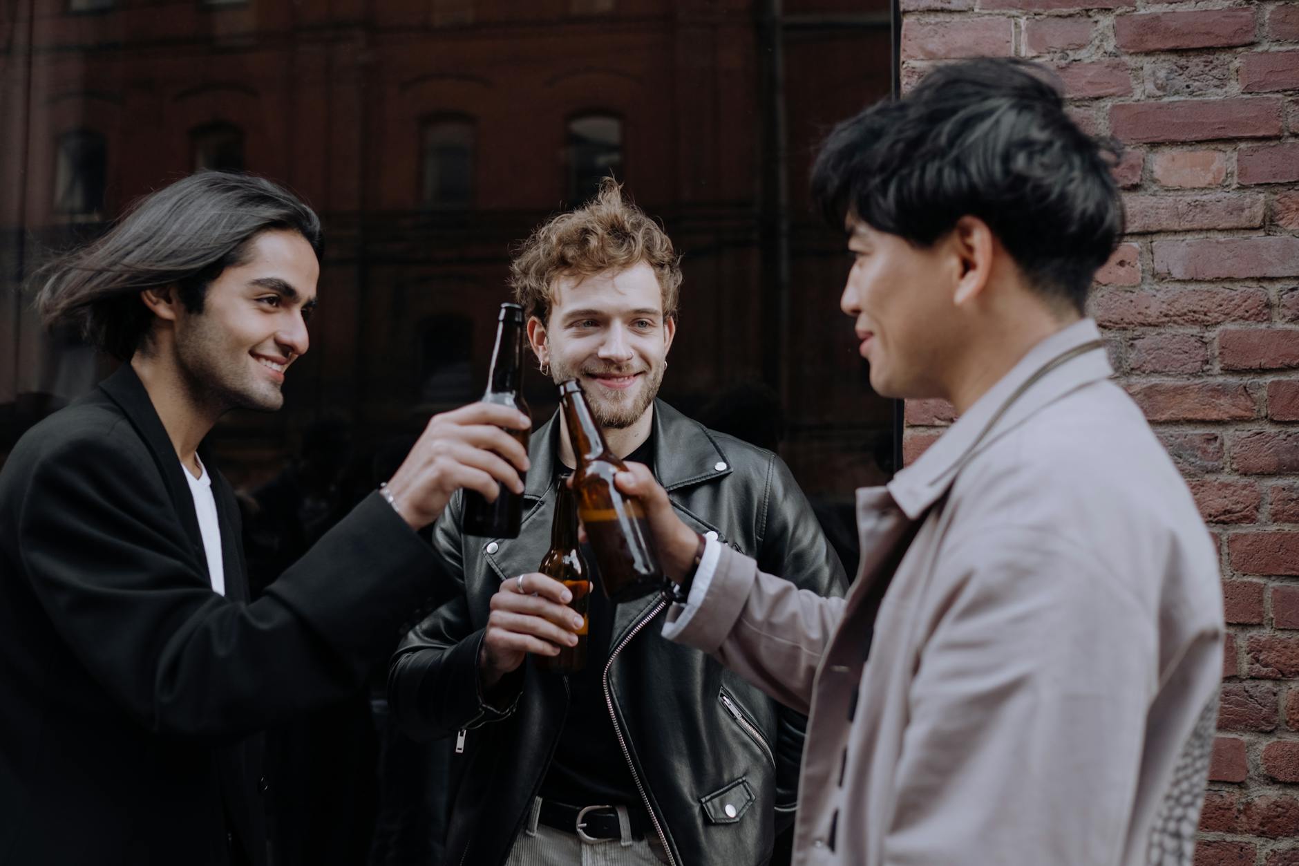 men drinking beers in the street