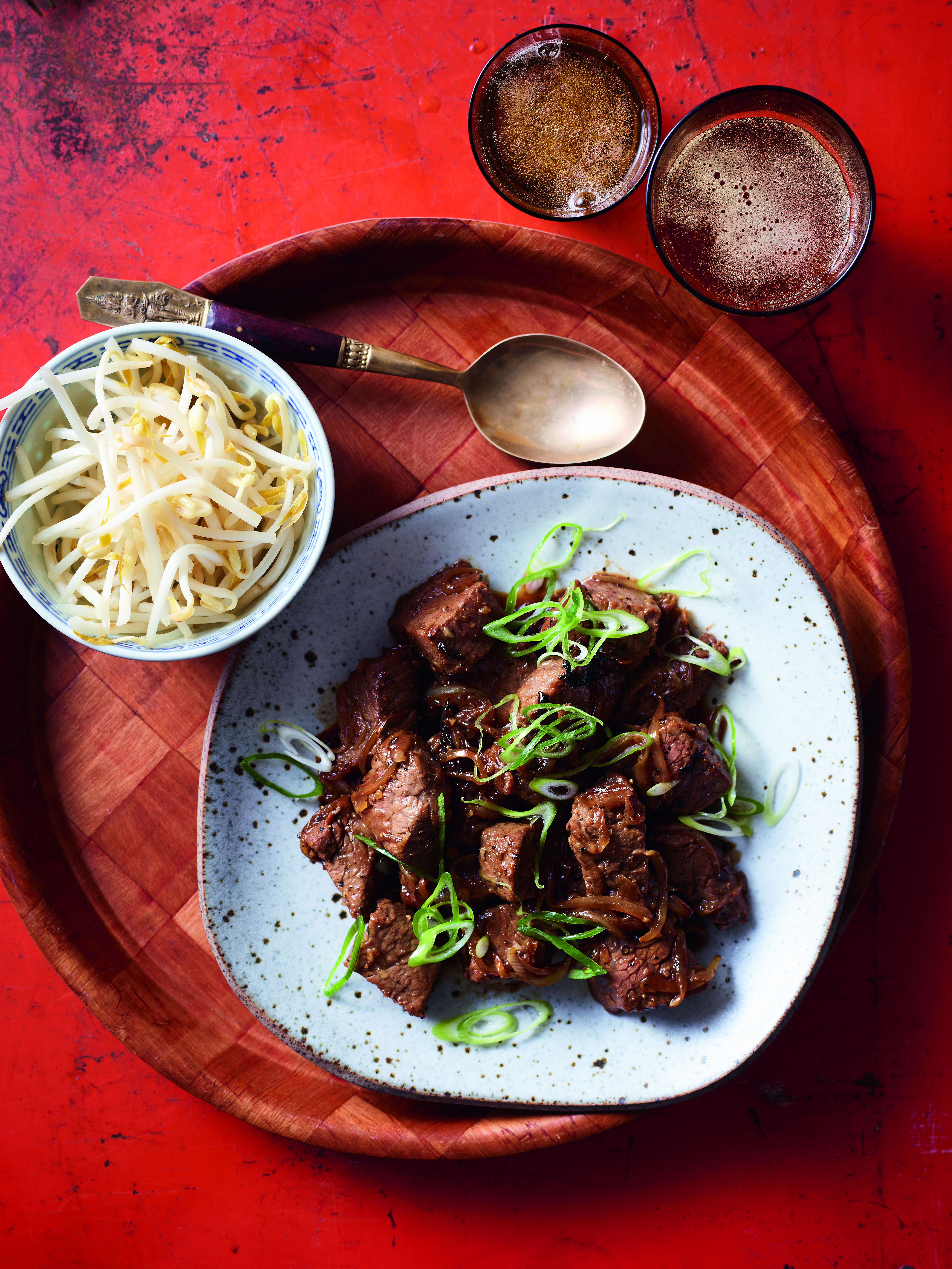 Beef garnished with Spring onions and Pickled Bean sprout on the side