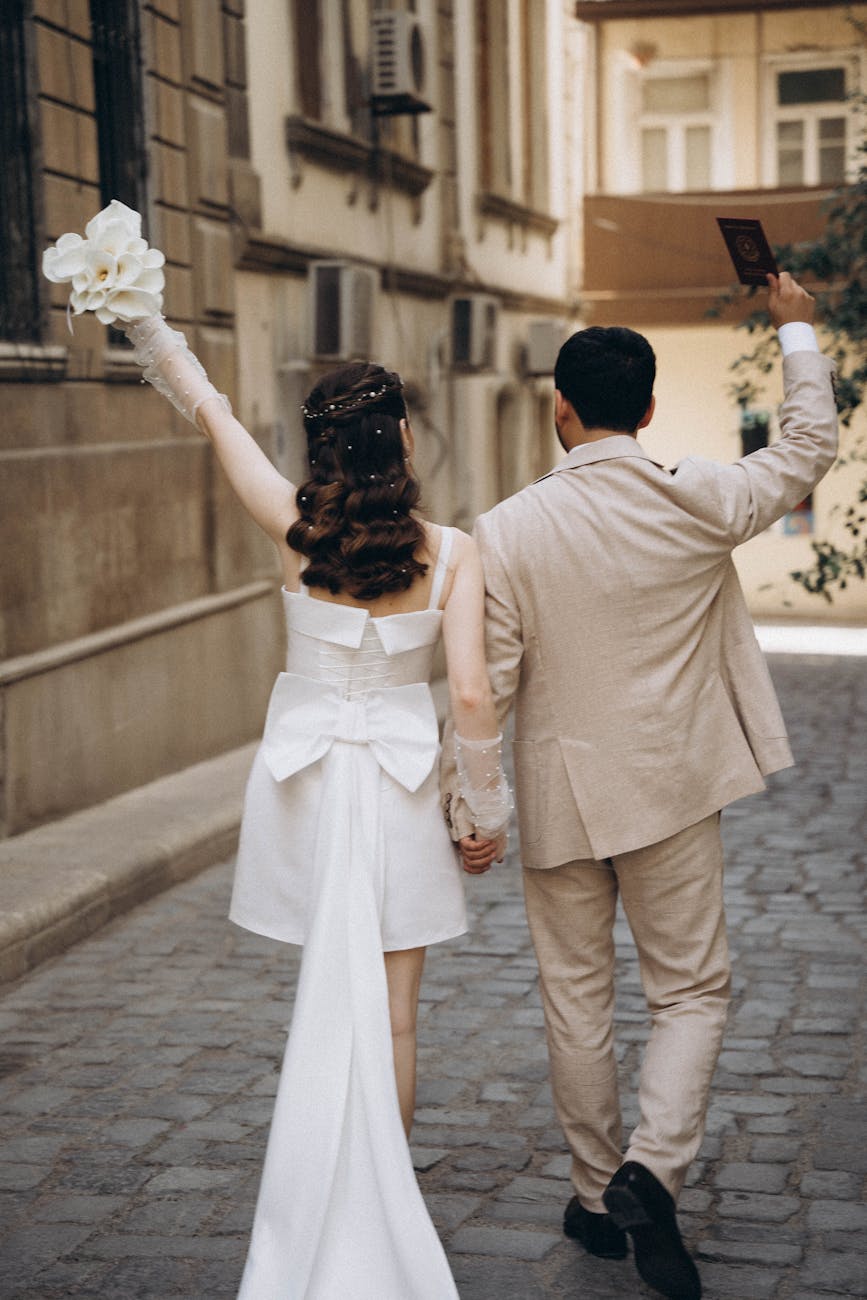 newlyweds walking on street in old town in baku