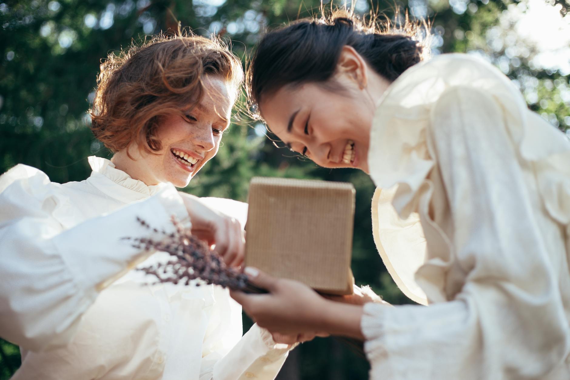 smiling women with gift in park