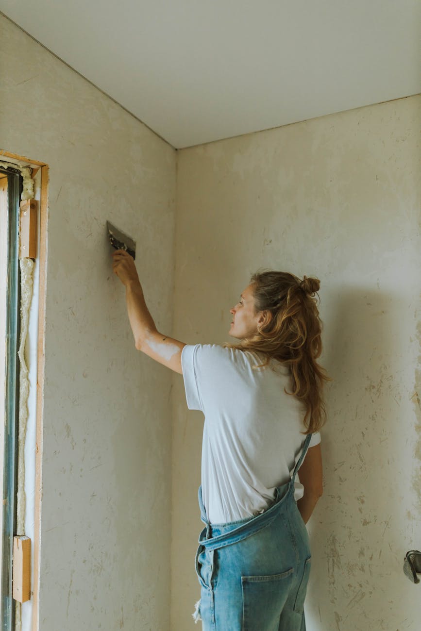 blonde woman polishing wall