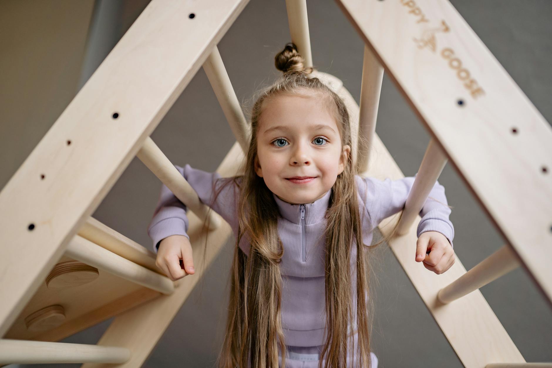 smiling girl under wooden ladder