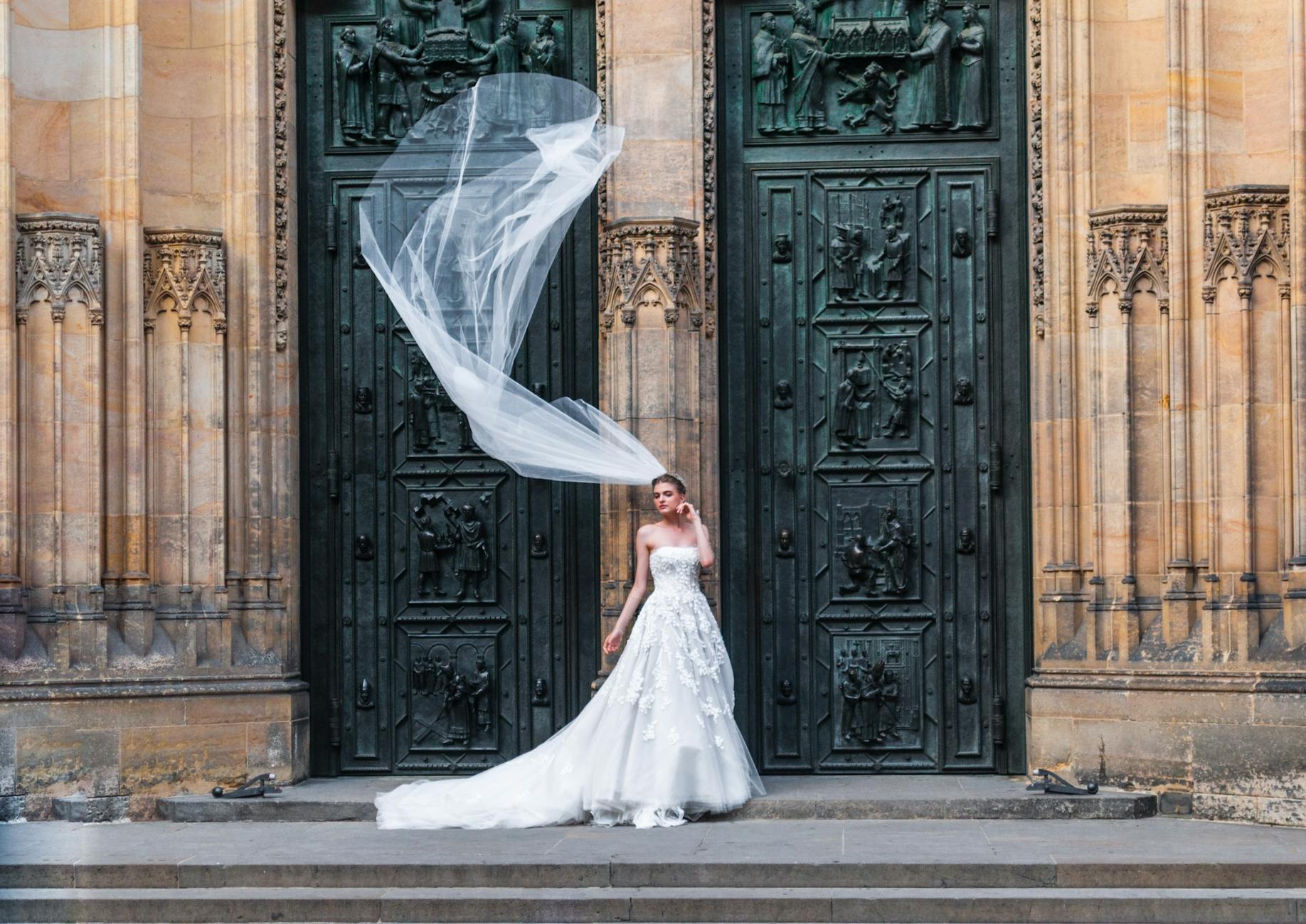woman wearing wedding dress standing near closed doors