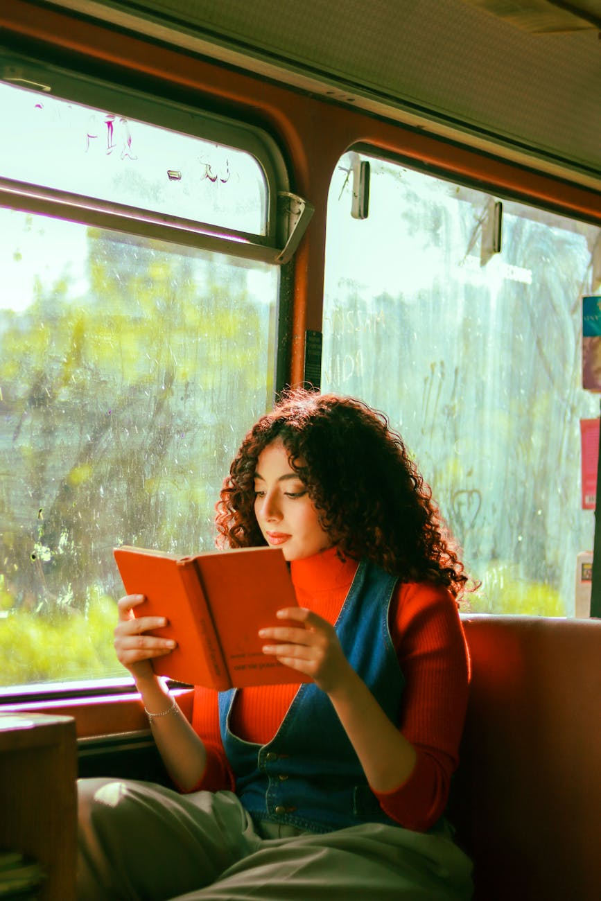 brunette reading book on bus