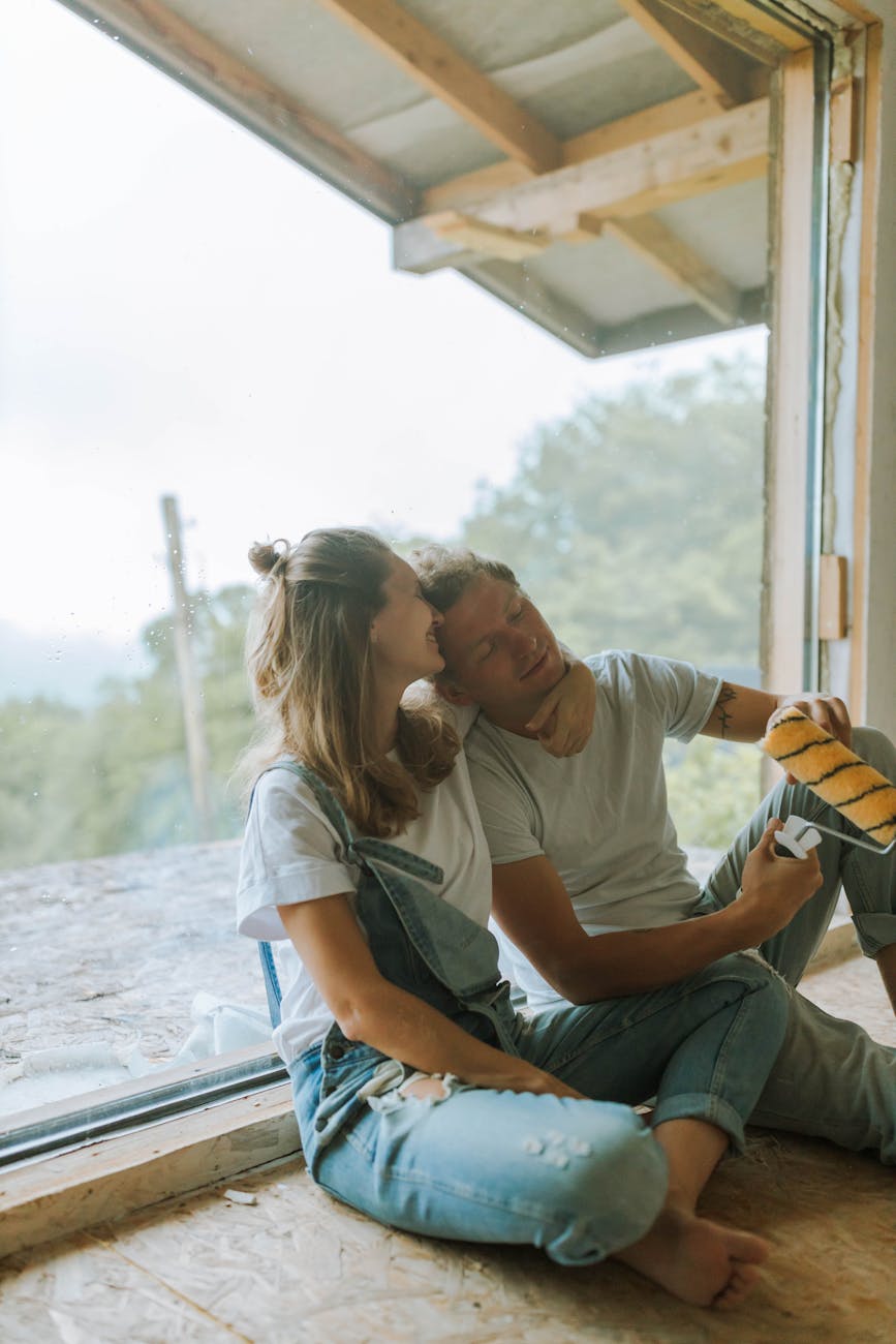 a couple sitting beside the glass panel