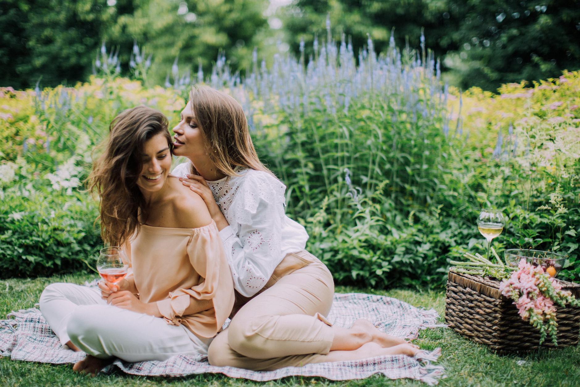 women sitting on a picnic blanket