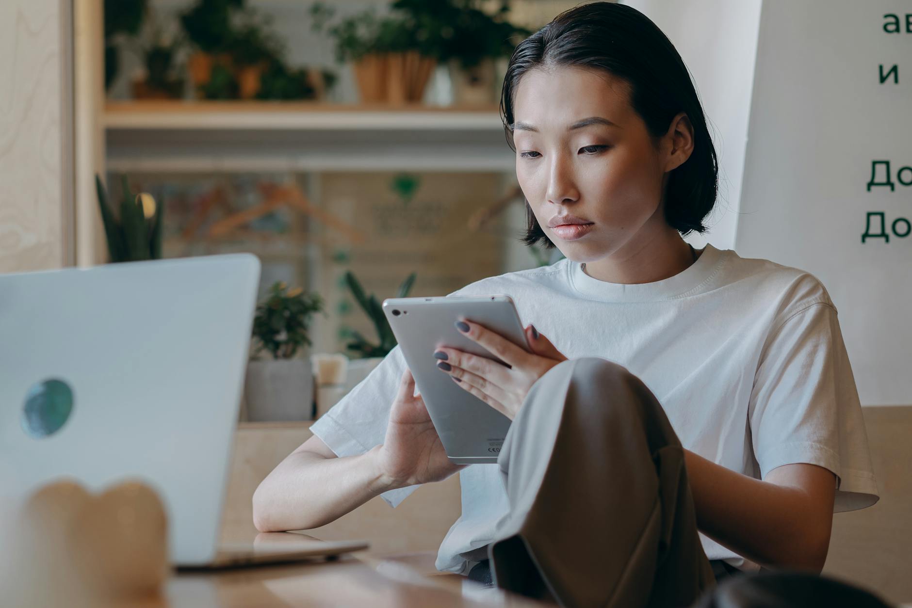 businesswoman in white shirt using her tablet computer