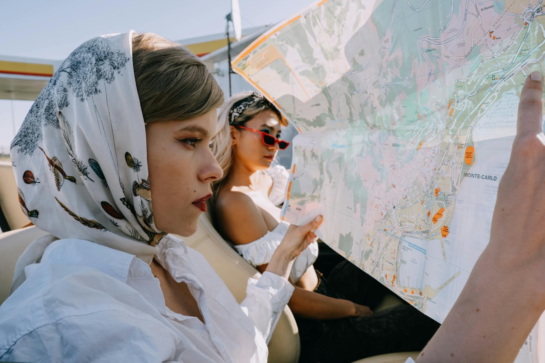 a beautiful woman looking at a map