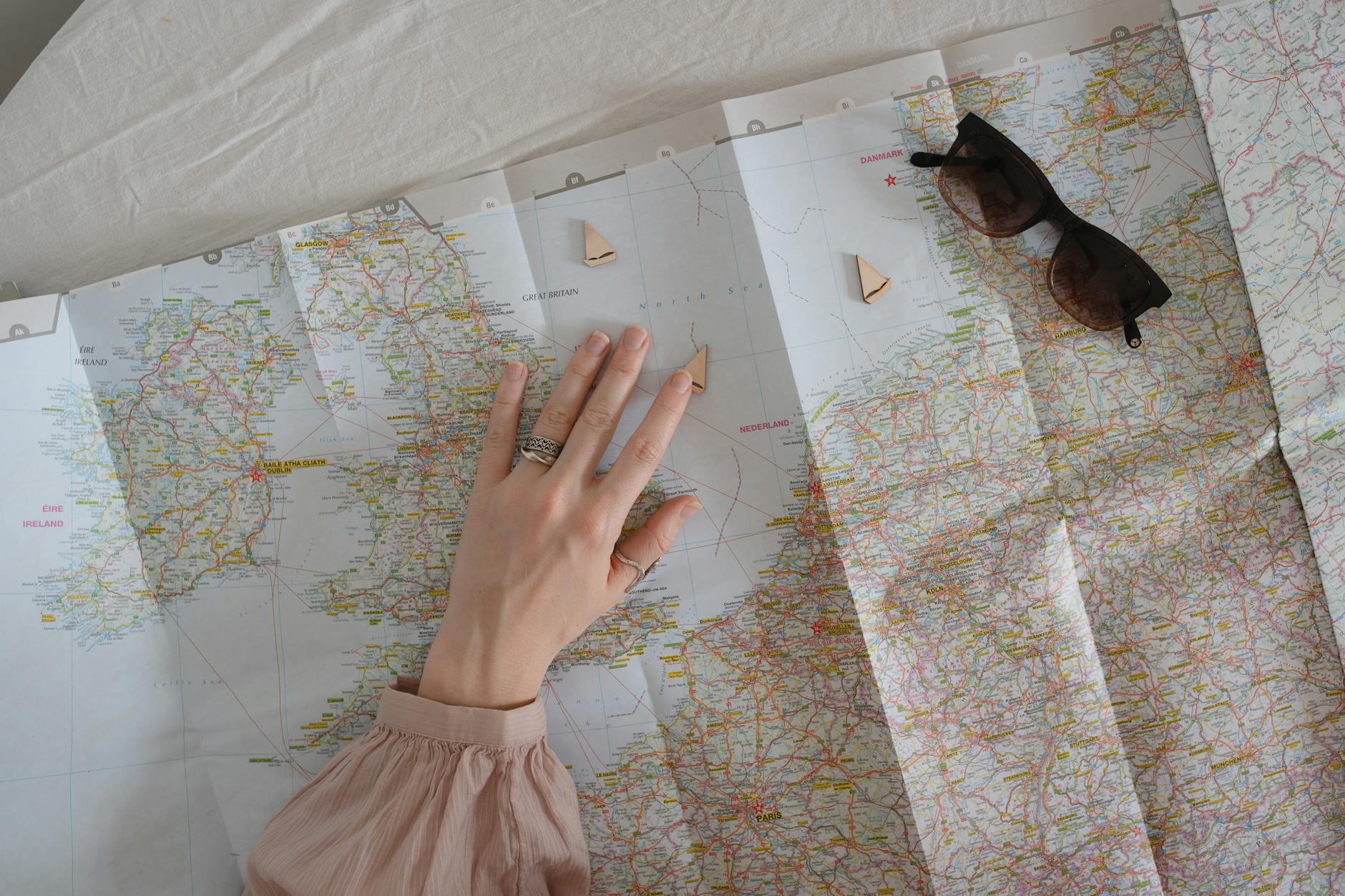 a woman s hand over a map