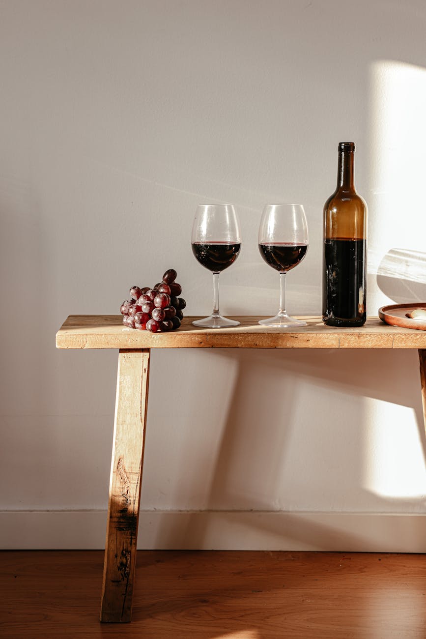 wine bottle and wine glasses on wooden table