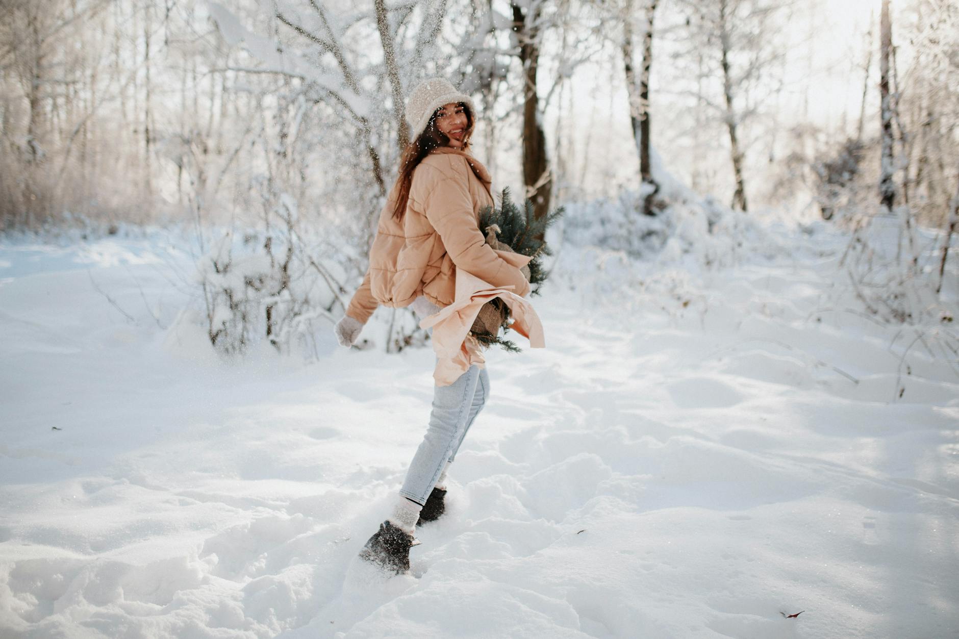 beautiful woman with christmas tree on winter day