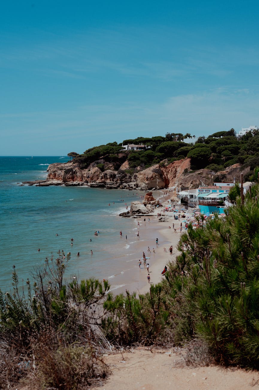 a beach with people and a blue sky