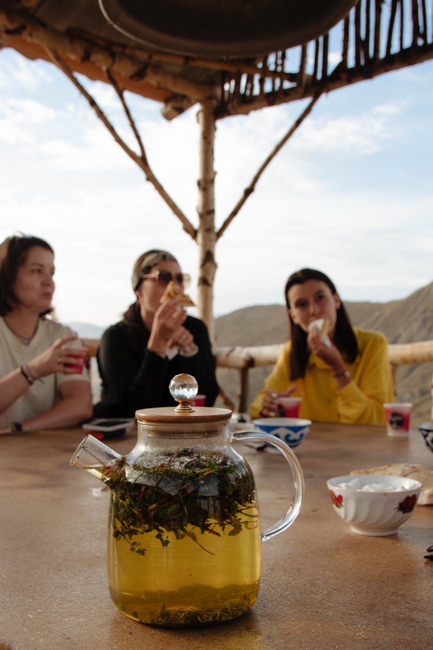 pitcher on table and people sitting behind