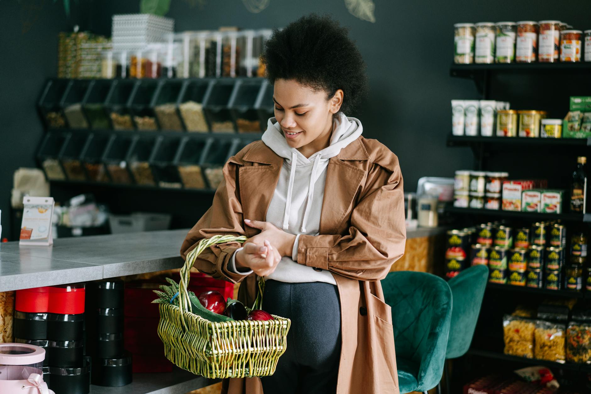 pregnant woman holding basket with groceries