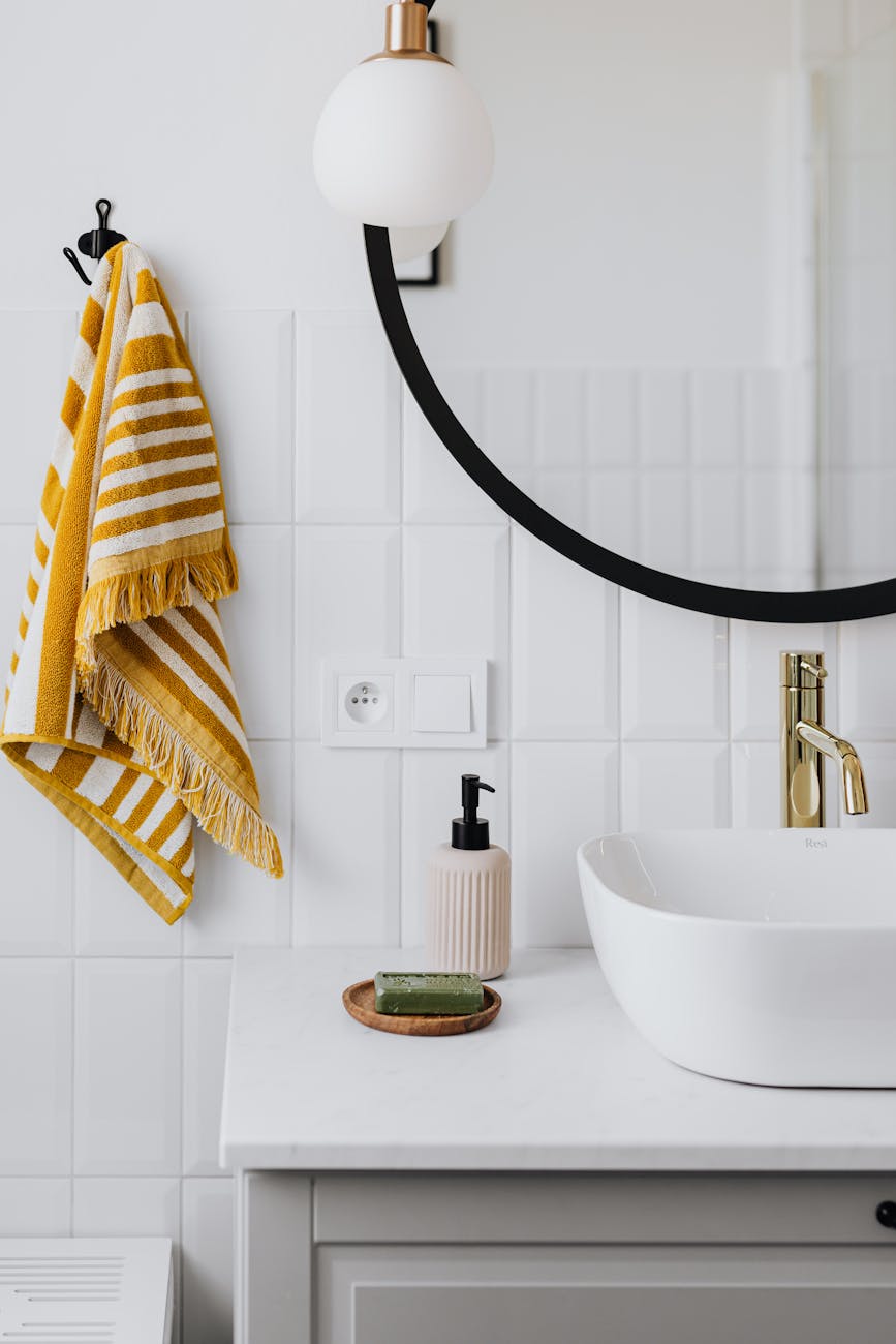 yellow towel beside mirror