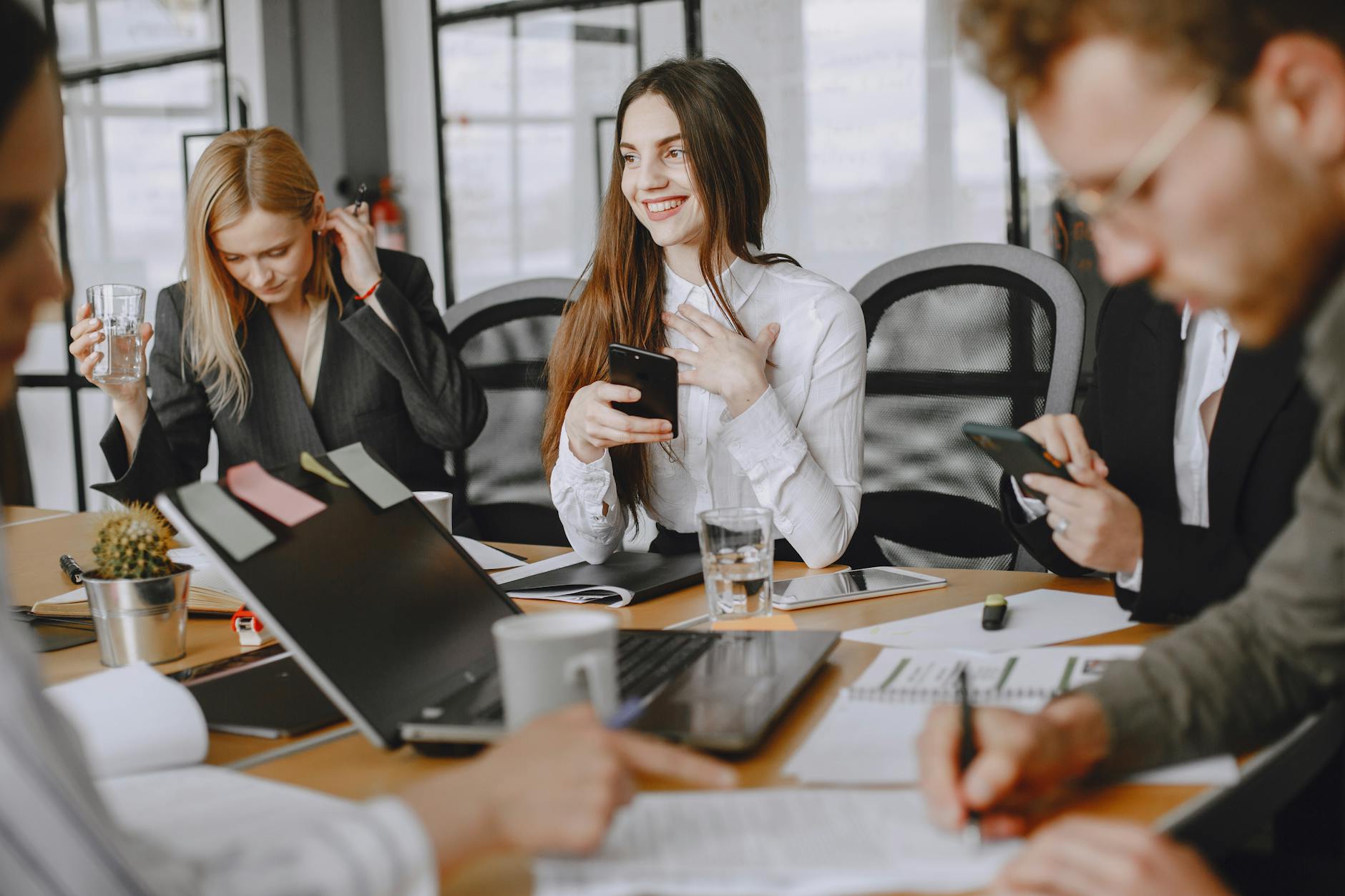 a woman smiling while holding a cellphone