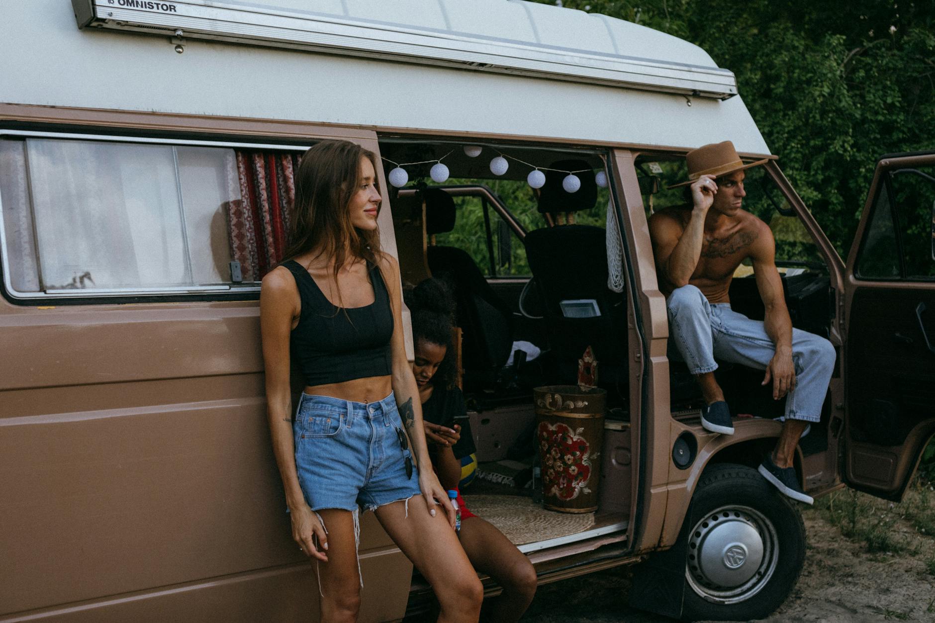friends hanging out by the side of a camper van