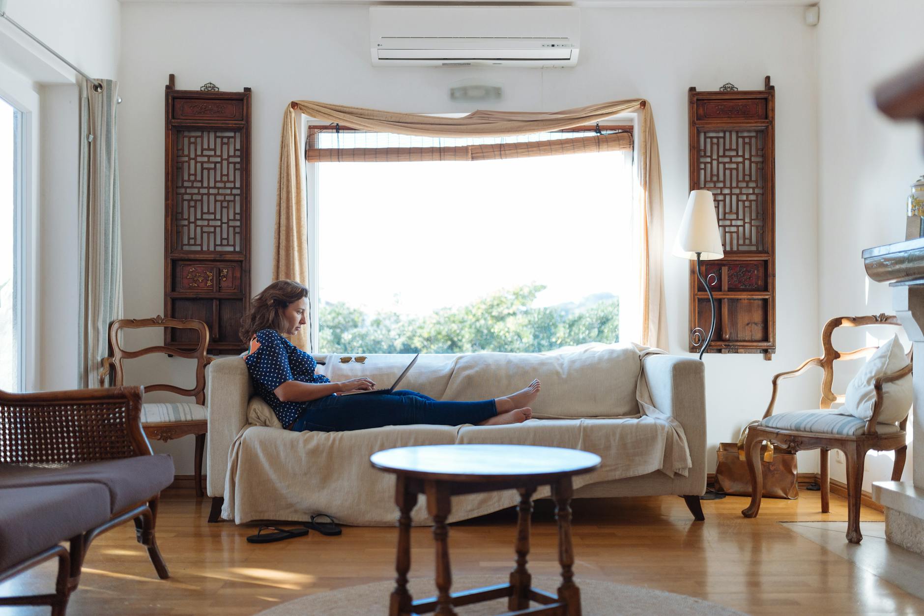 woman sitting on sofa in living room