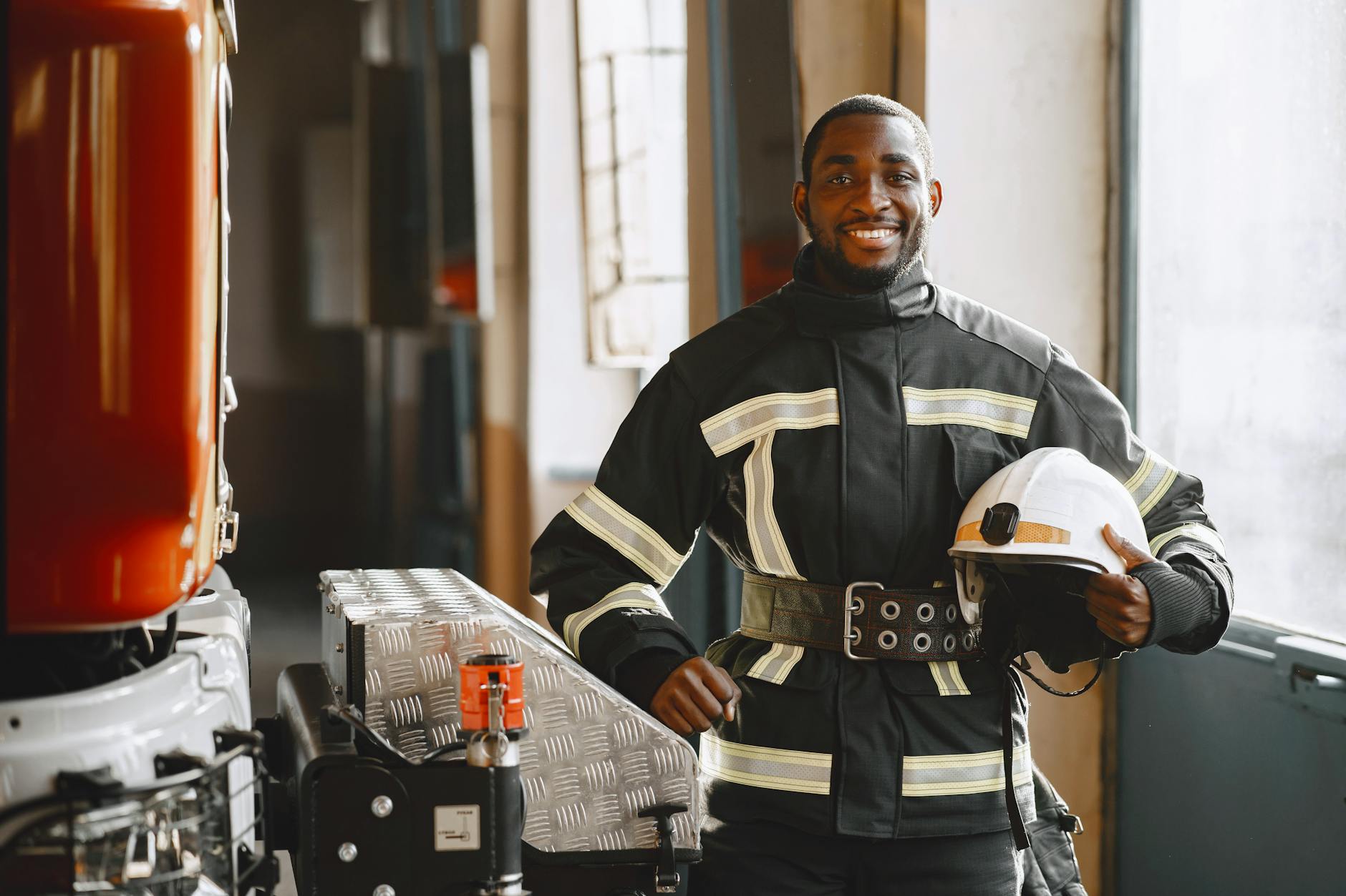 a man holding a helmet while smiling at the camera