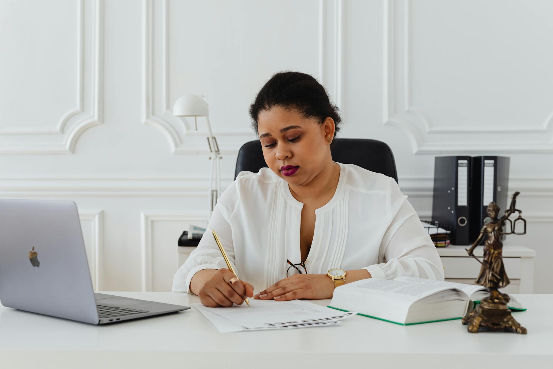 woman at her office signing a contract