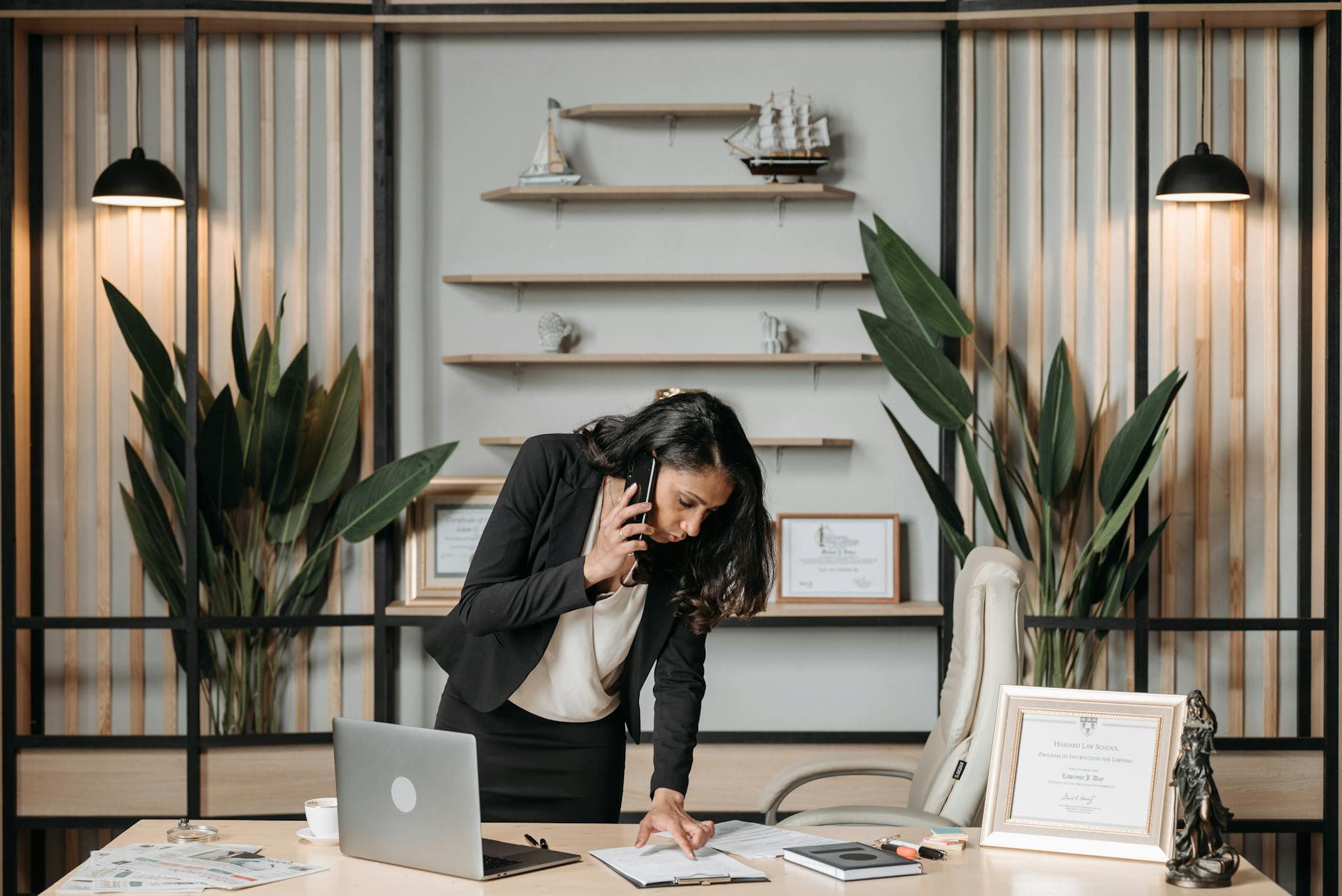 female lawyer having a phonecall while looking at documents