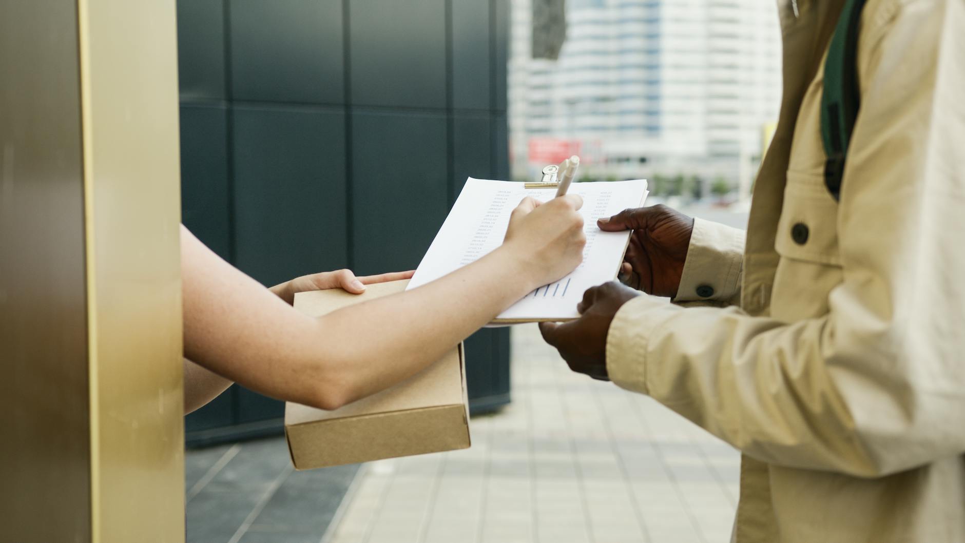 a person signing a proof of delivery