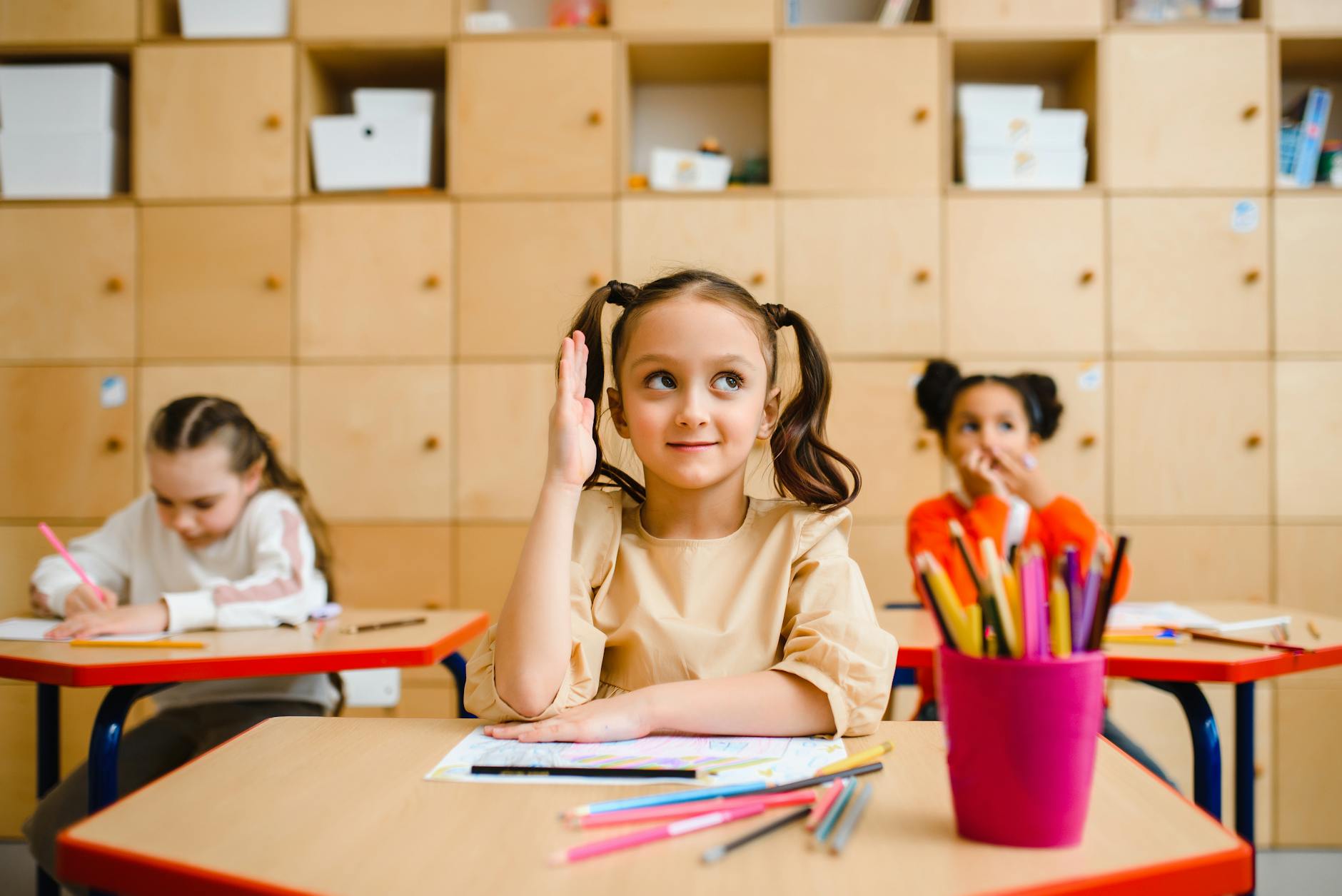 girl sitting at her desk at her school