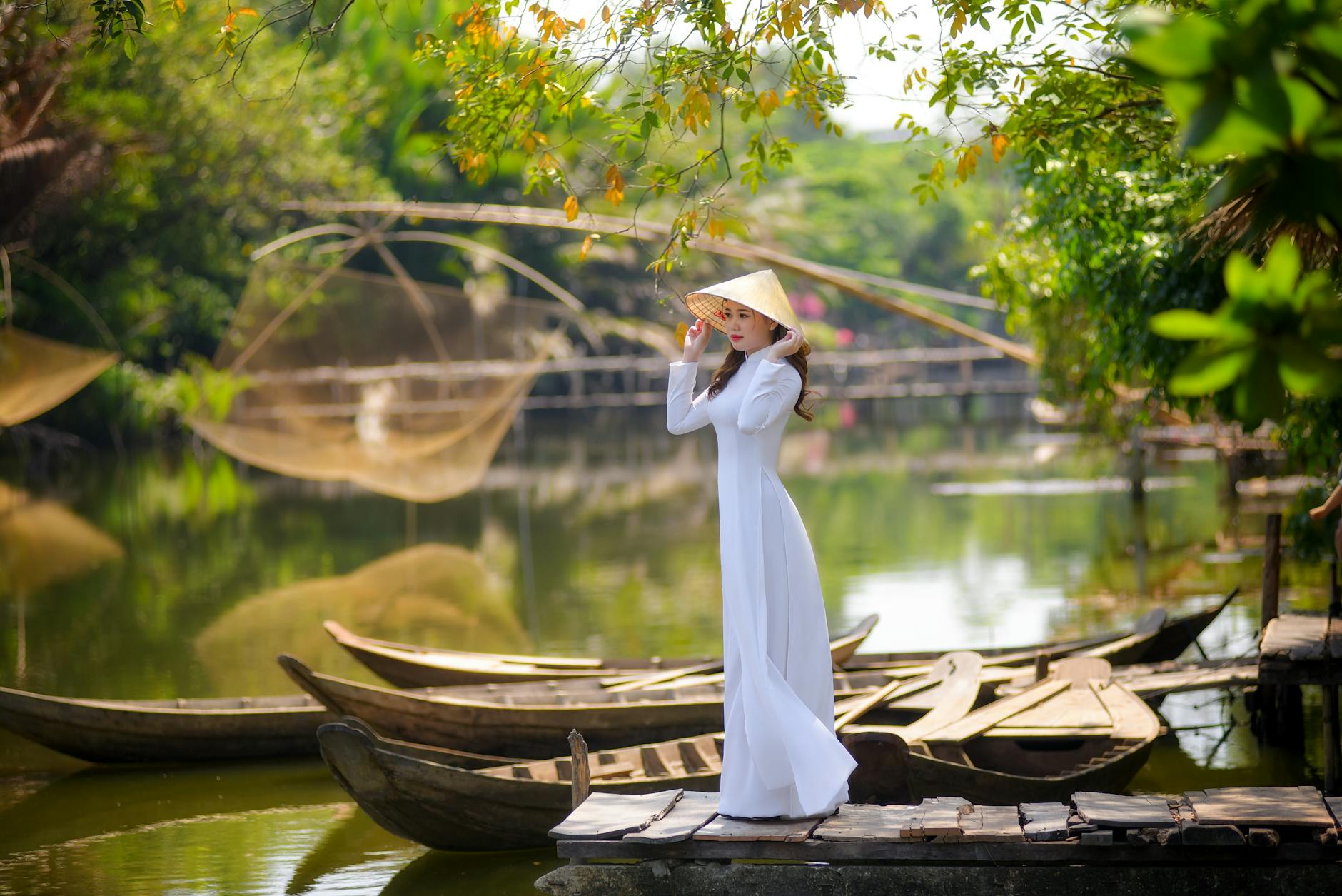woman in white dress wearing a straw hat