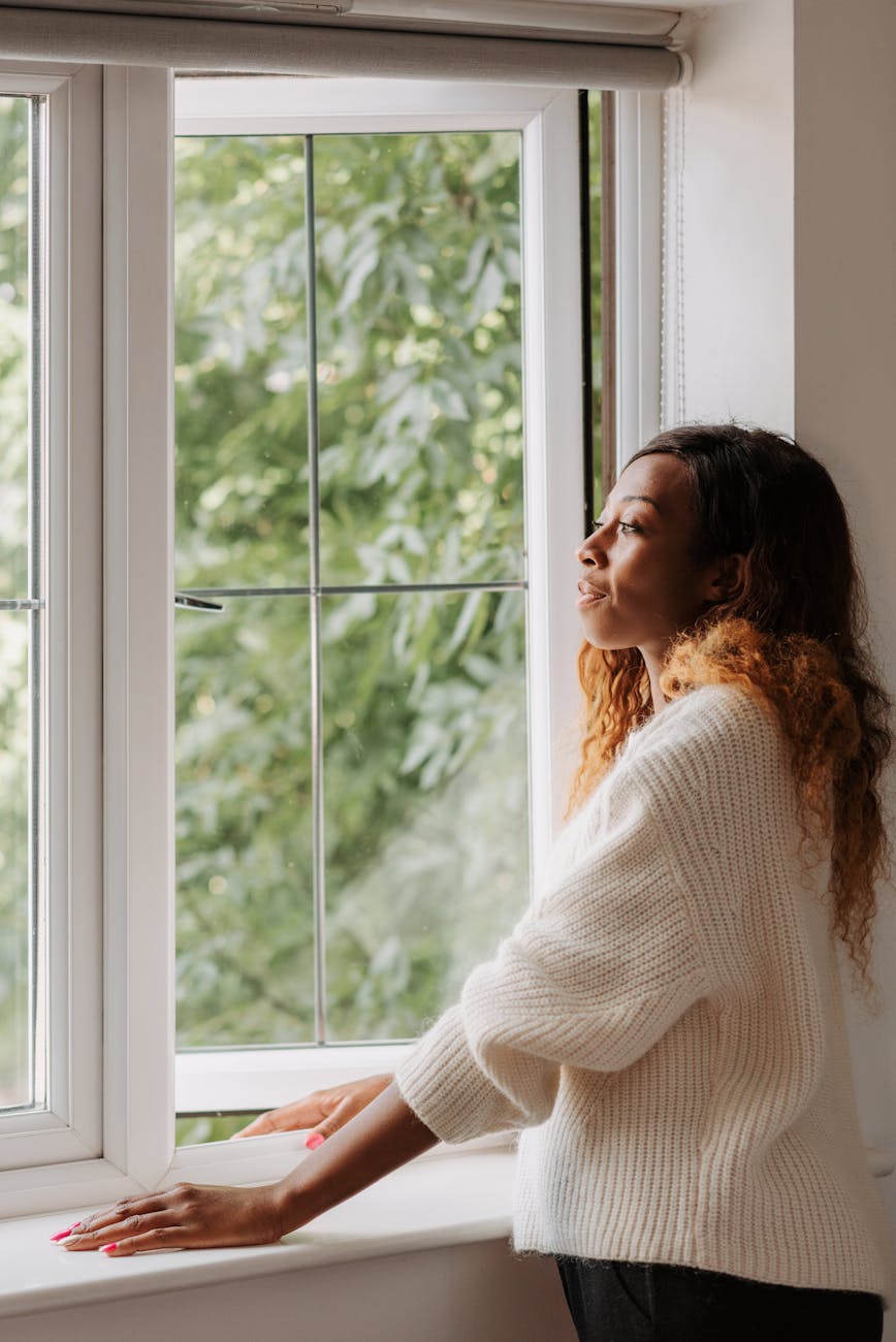 woman looking through window