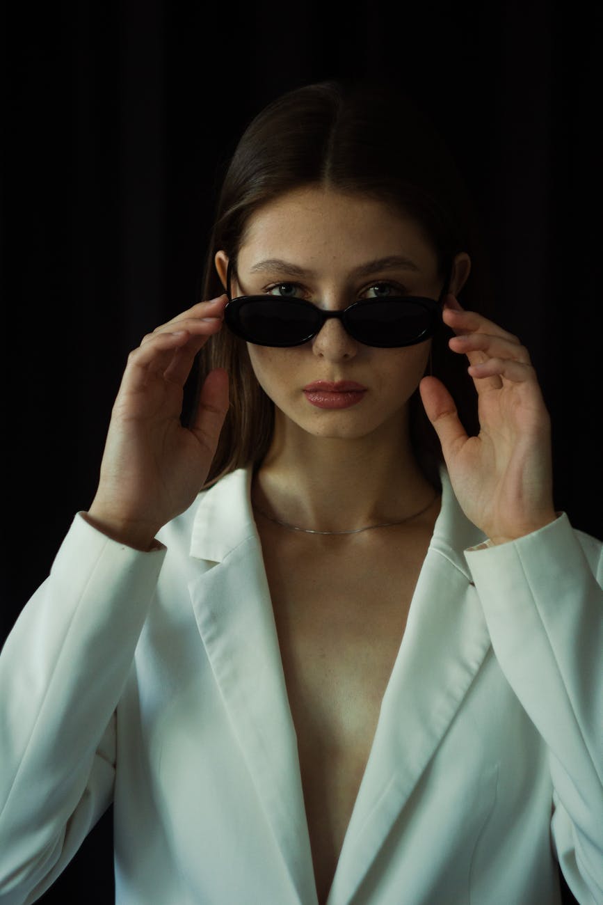 a female looking at camera above sunglasses