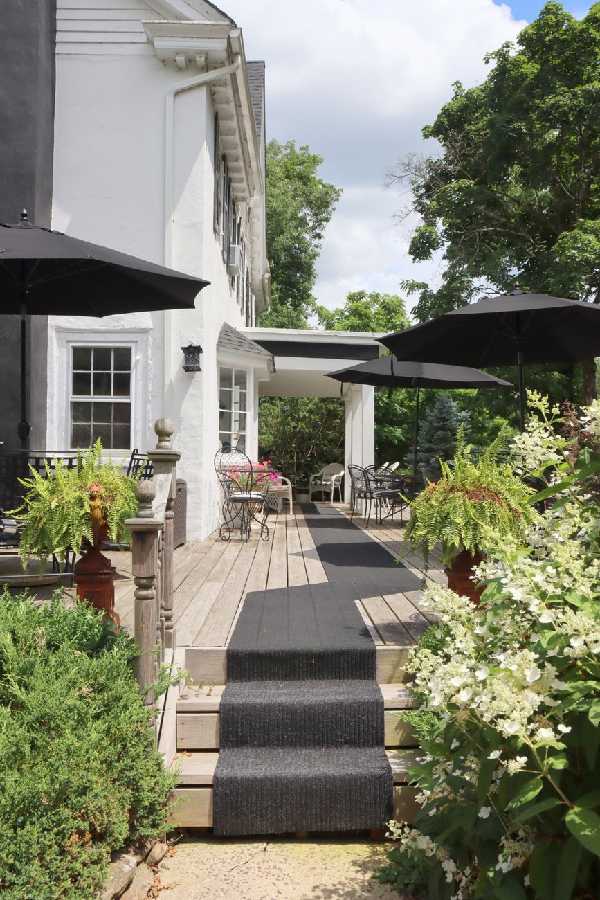 residential house with tables and chairs on a patio