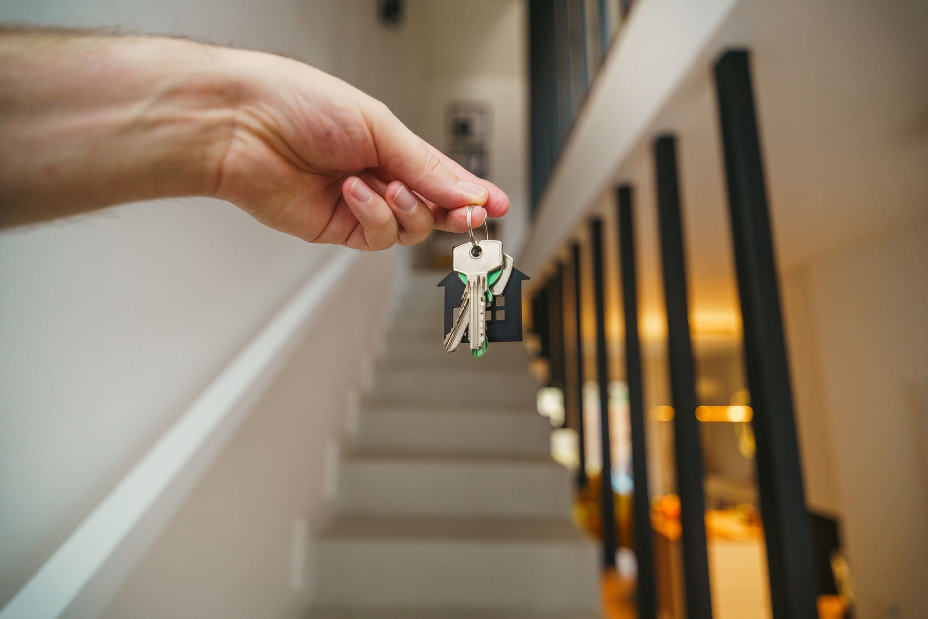 hand holding house keys in modern interior