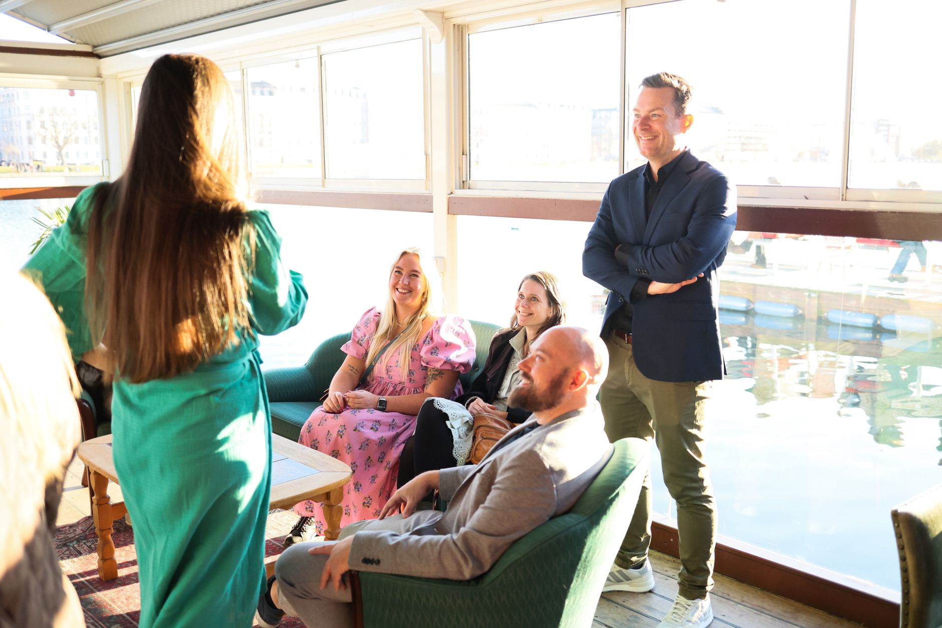casual indoor gathering overlooking water