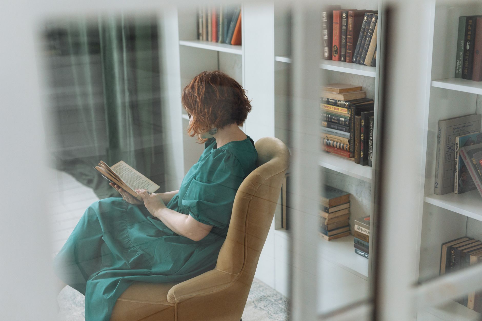 a woman reading book in the library